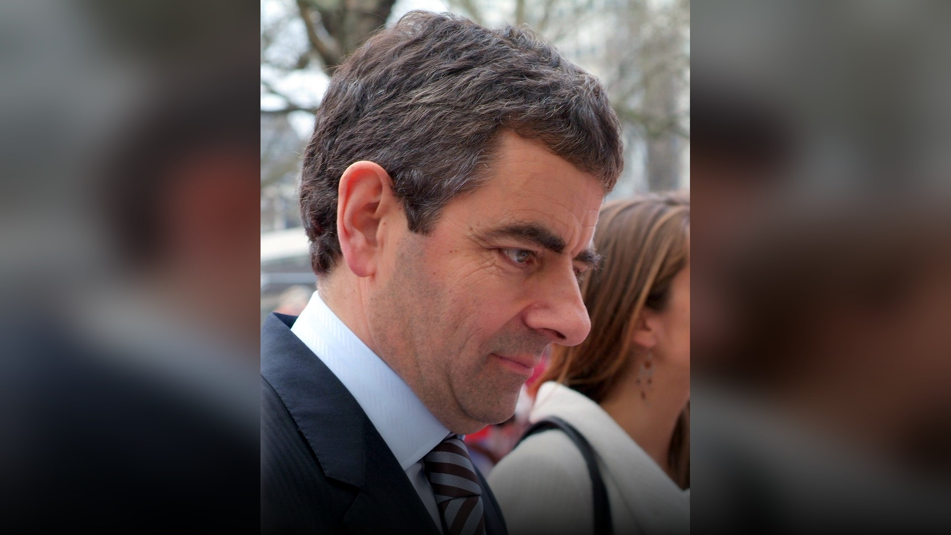 High-resolution portrait photograph of Rowan Atkinson celebrating academic achievement.