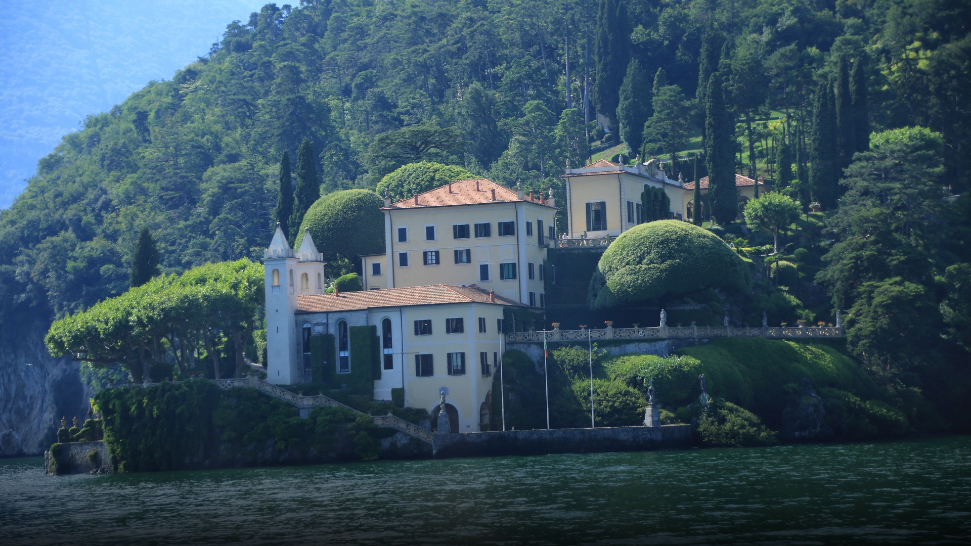 Villa del Balbianello and its terraced gardens perched above the deep blue waters of Lake Como.