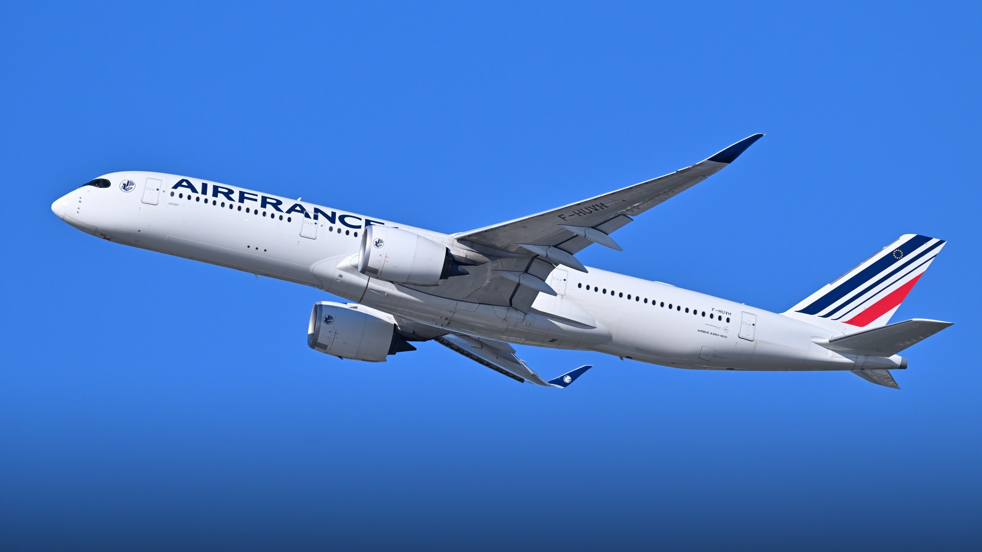 An elegant Air France Airbus A350-900 widebody aircraft ascending gracefully into clear skies.