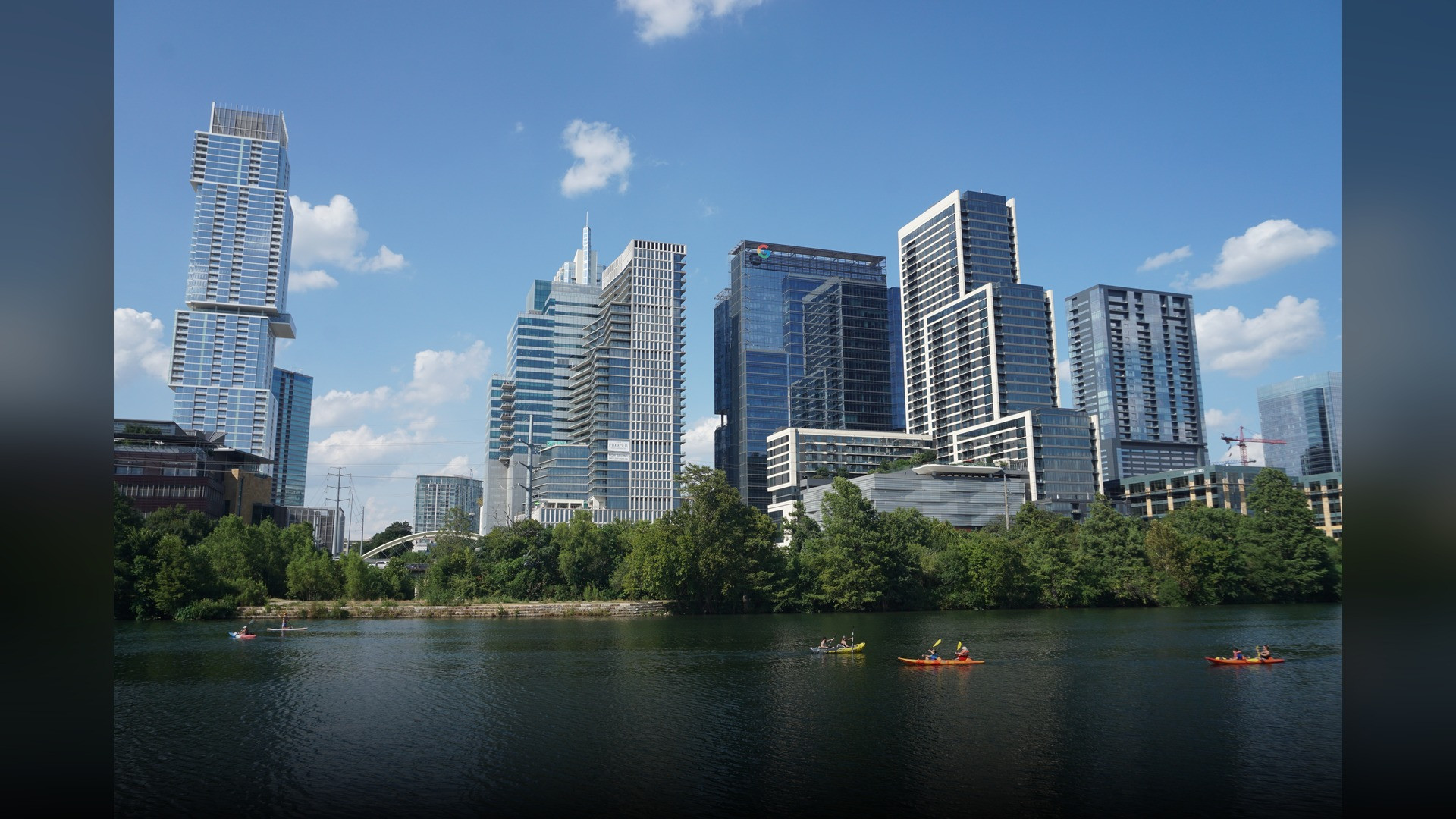 Modern high-rise skyline of downtown Austin Texas reflected in Lady Bird Lake.