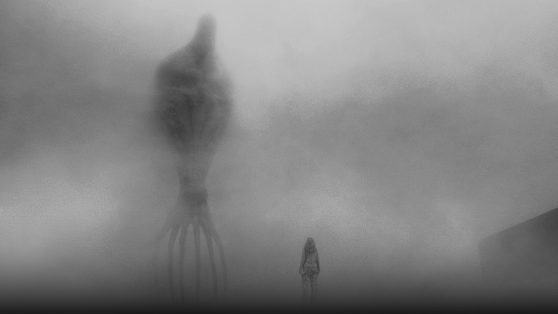 Towering heptapod alien silhouette emerging through dense white atmospheric fog in front of Dr. Louise Banks in Arrival.