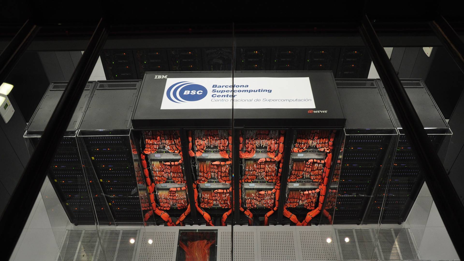 Rows of supercomputer cabinets housed within the former chapel of the Barcelona Supercomputing Center.