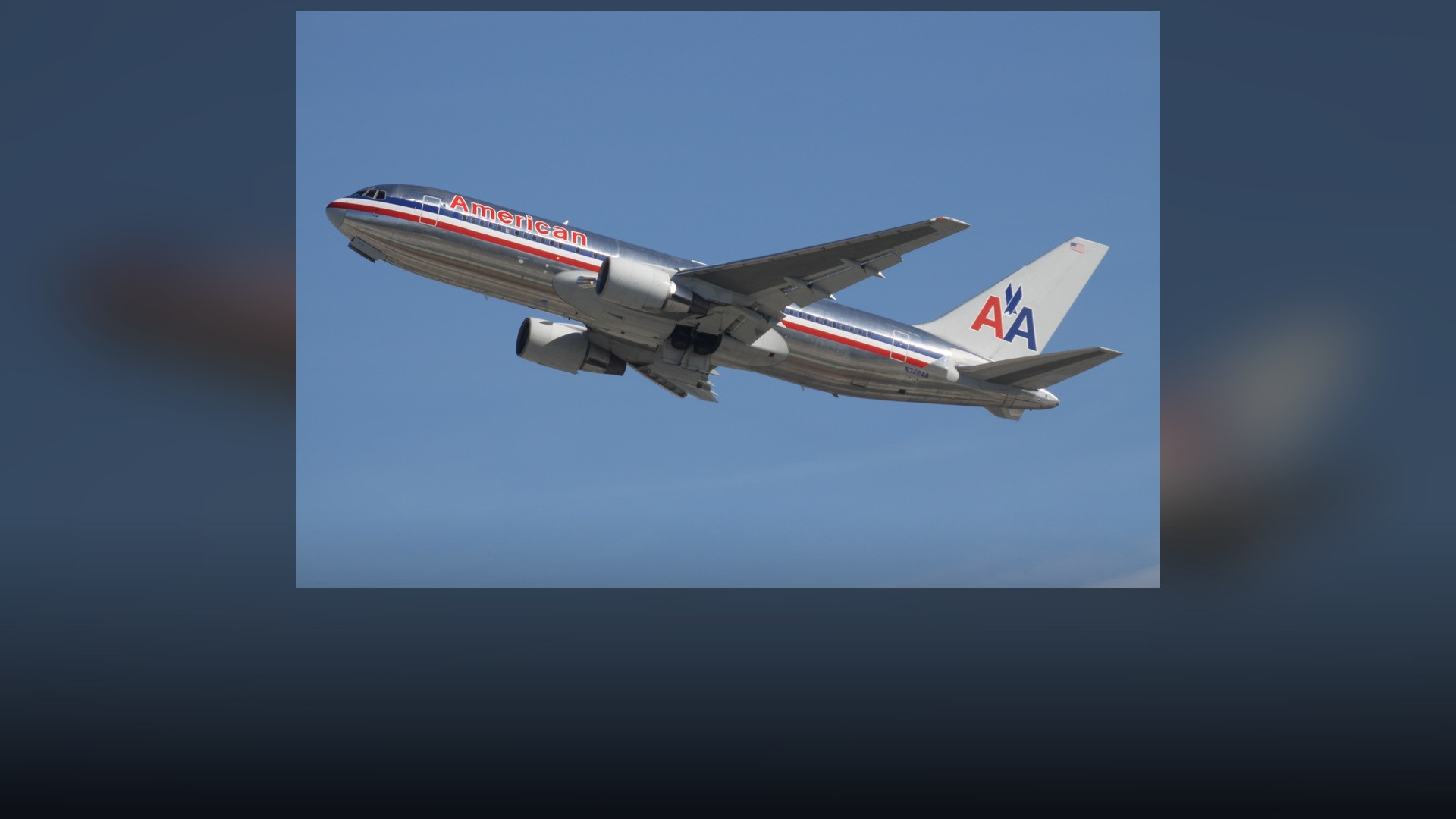 American Airlines Boeing 767 in classic bare polished metal livery with red, white, and blue cheatline.