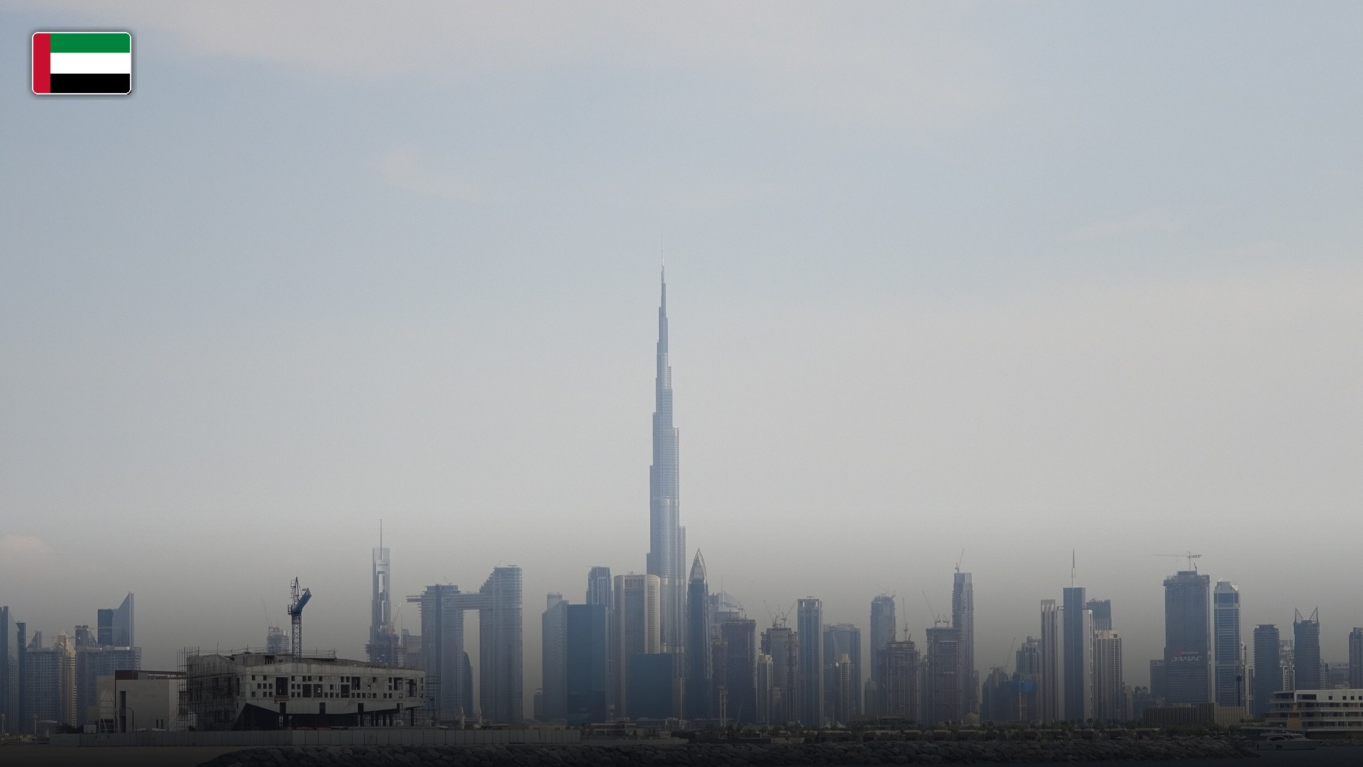 The Burj Khalifa piercing the Dubai skyline, with the flag of the United Arab Emirates.