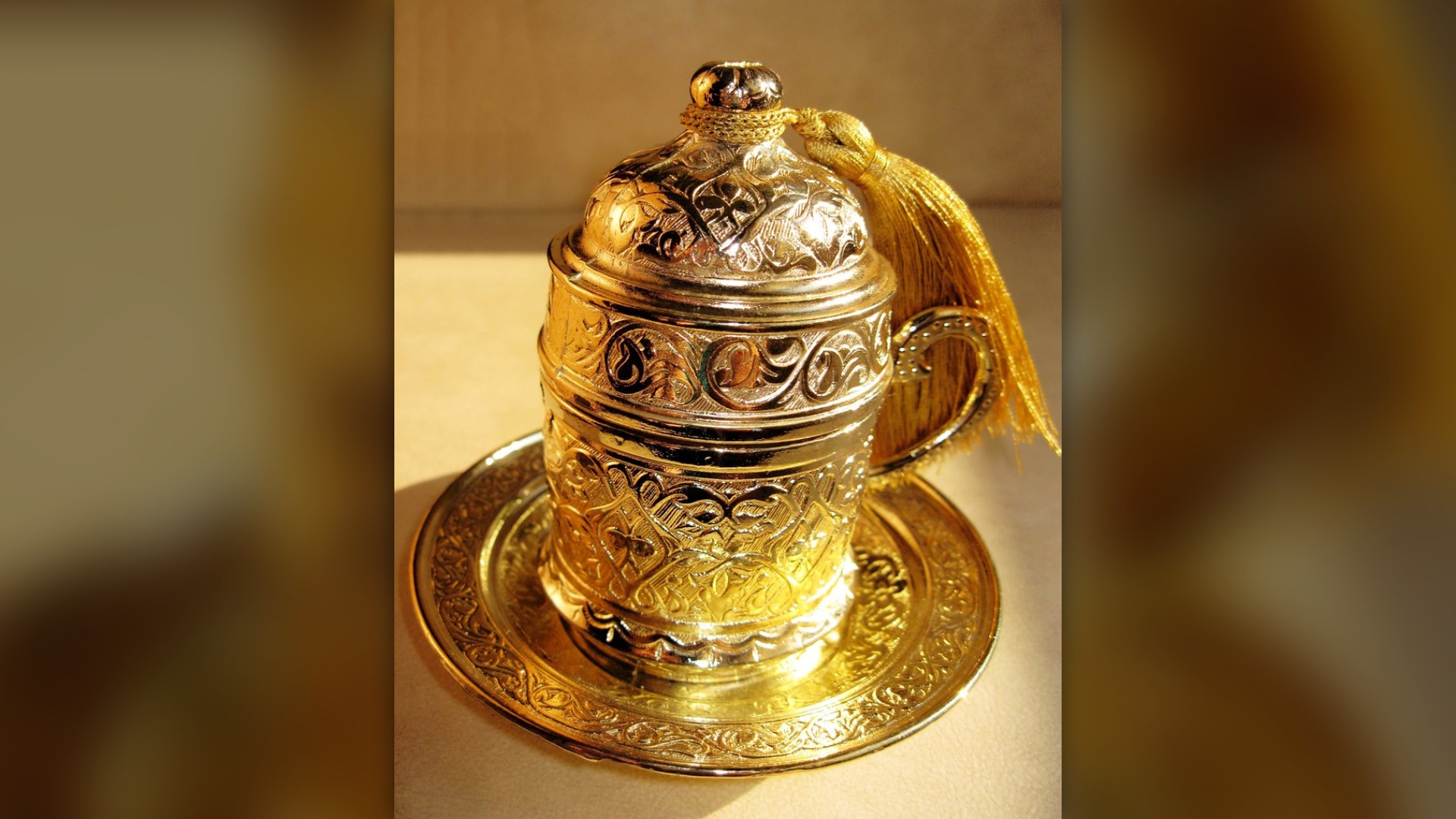 Ornate gold Turkish coffee demitasse cup with traditional decorative detail