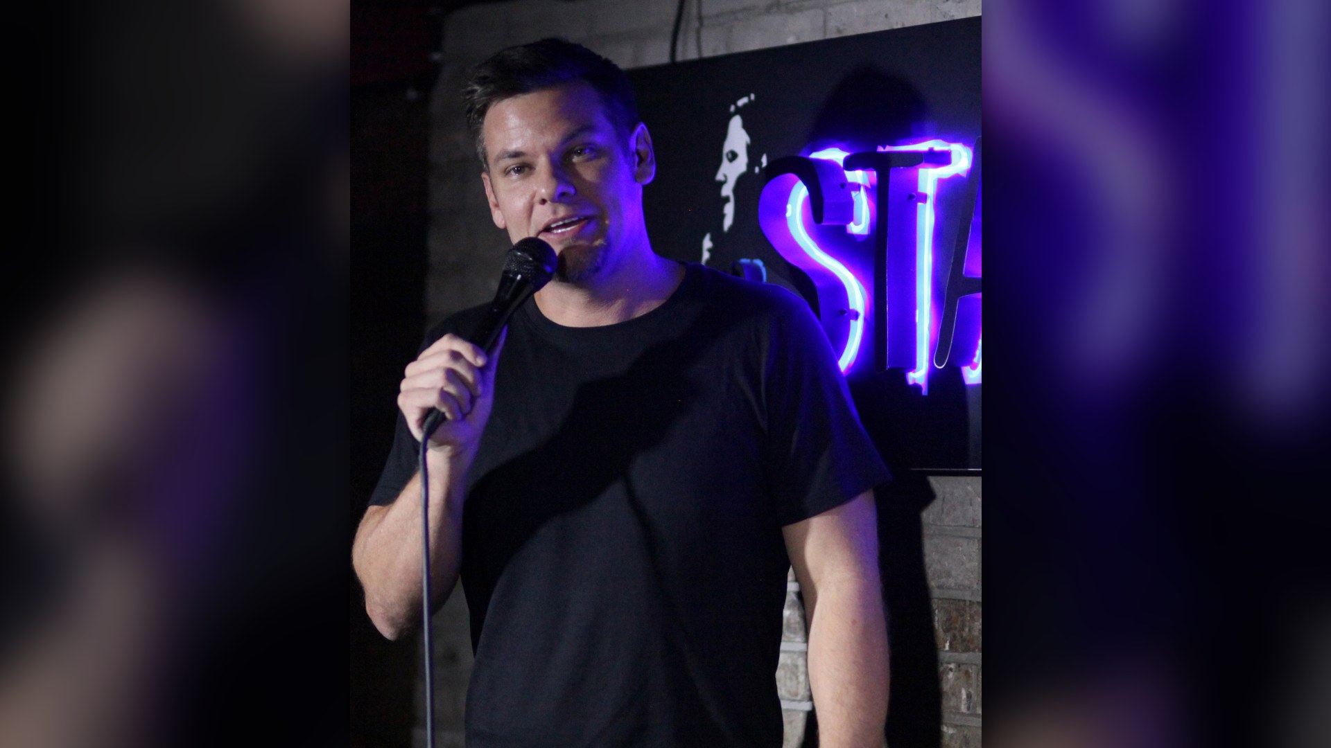 Comedian and podcast host Theo Von performing with a microphone