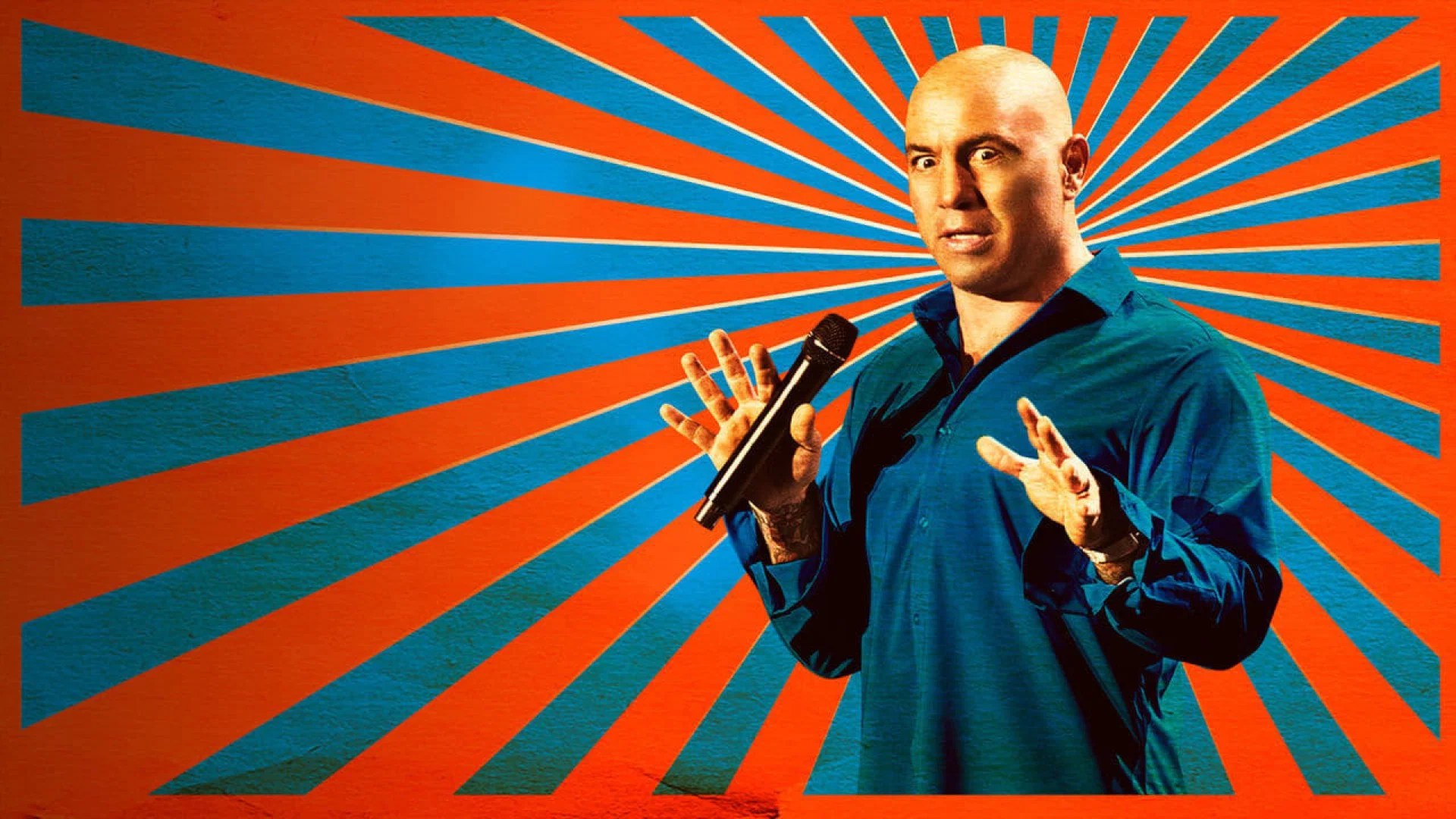 Comedian and podcast host Joe Rogan on stage with a microphone