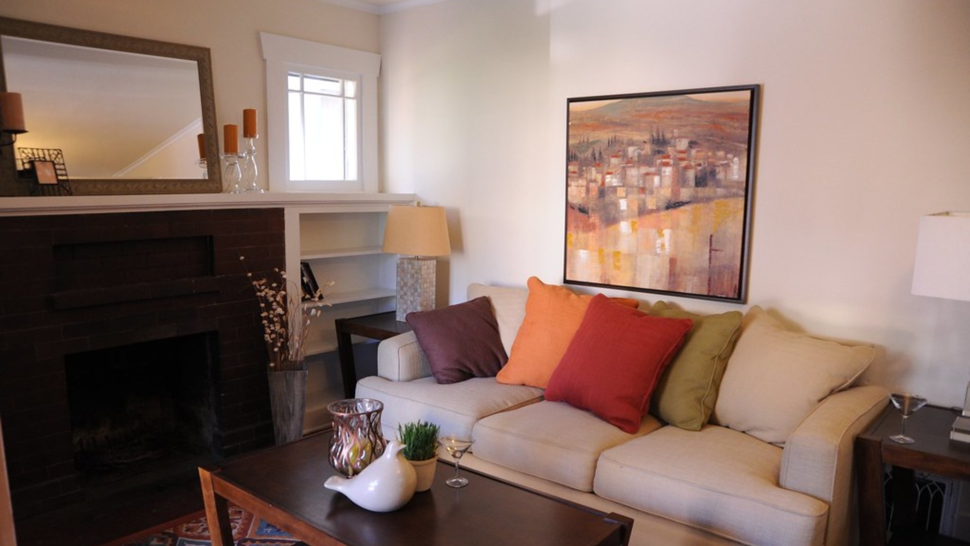 Styled sofa with brightly colored throw pillows in a living room
