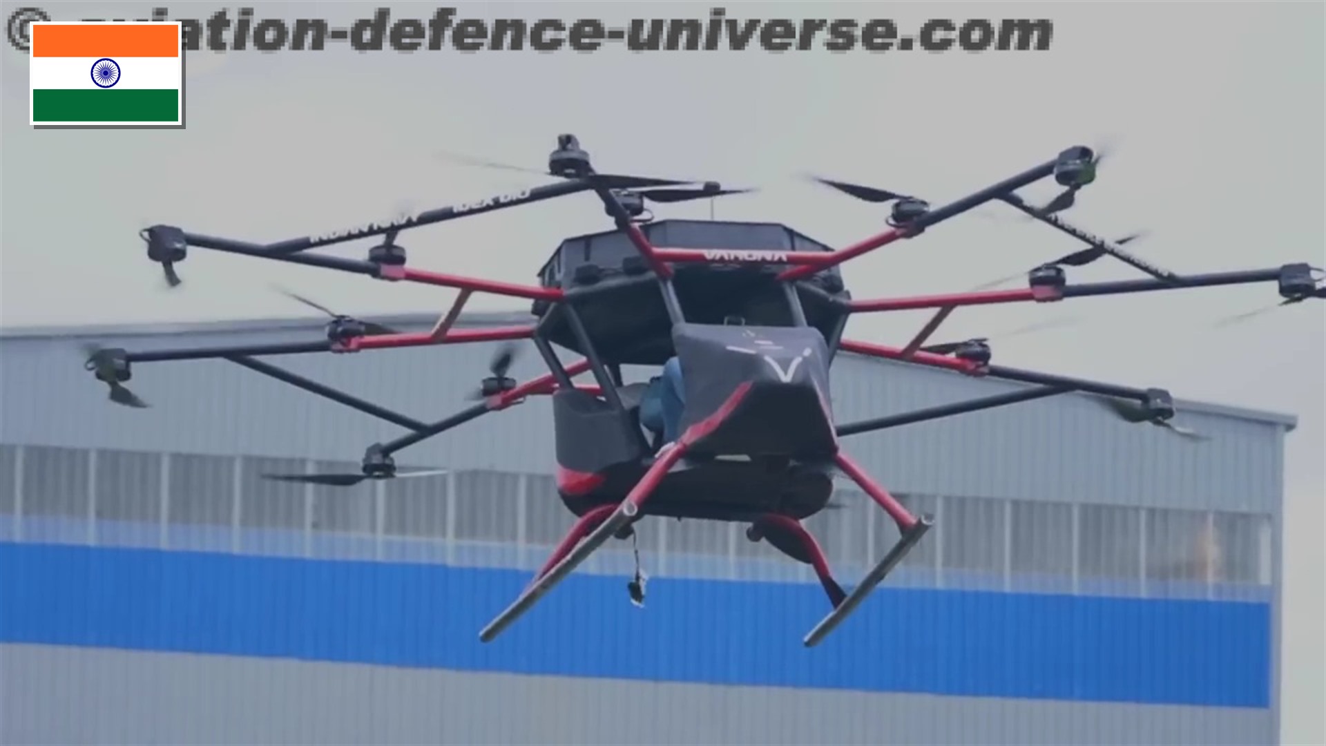 Sagawa Varuna human-carrying passenger drone developed for the Indian Navy with the flag of India in the top-left corner.