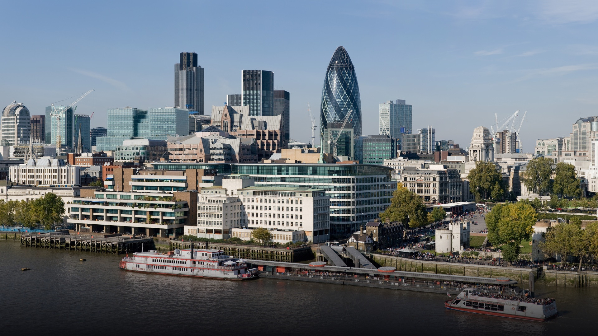 City of London commercial skyline with iconic financial skyscrapers under an overcast sky.