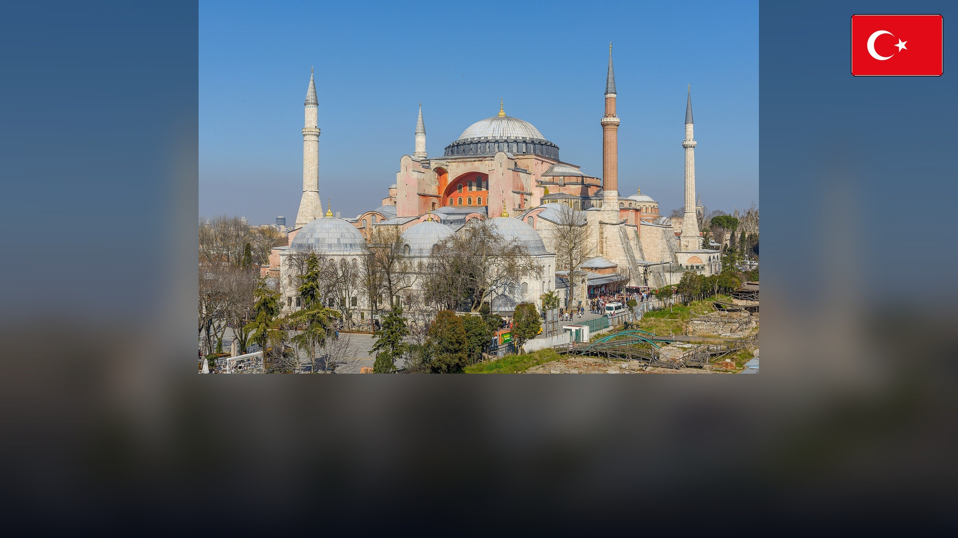 Hagia Sophia in Istanbul with the Turkish flag in the top right corner.