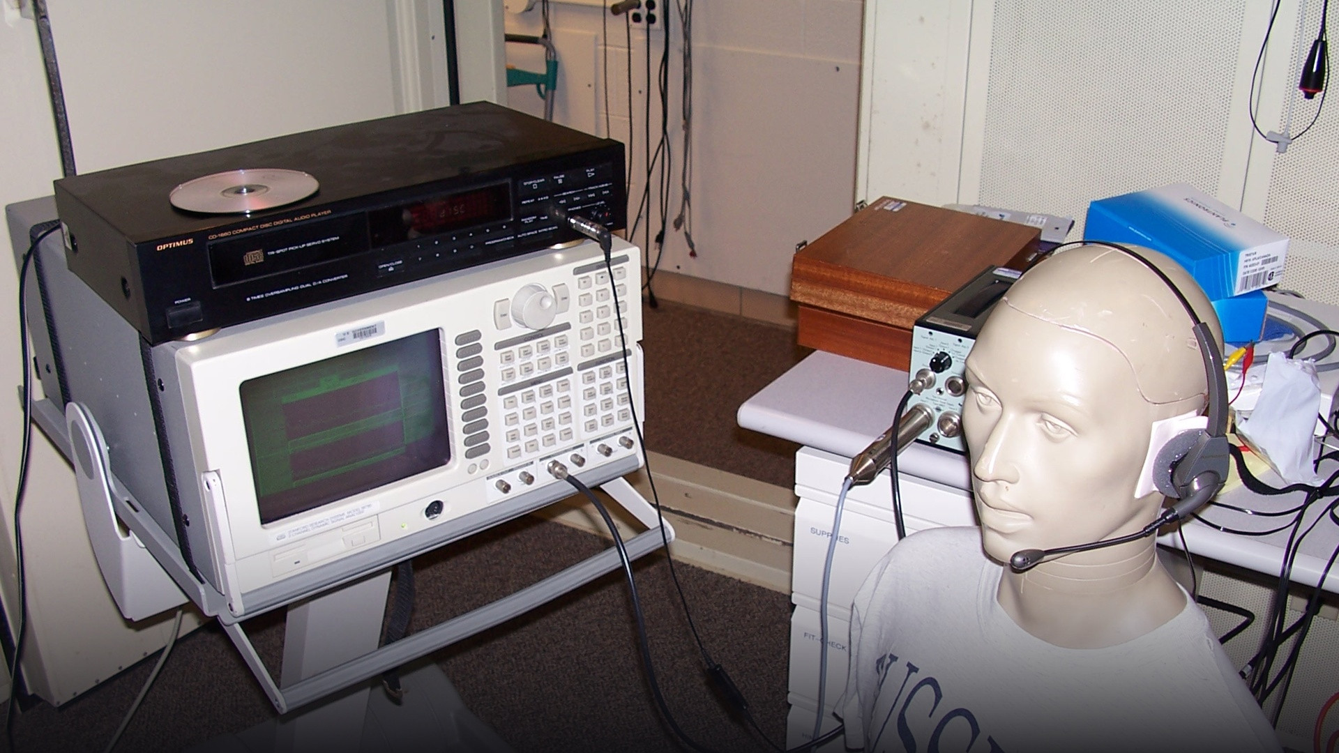 Professional customer service specialist wearing a communication headset speaking at an office workstation.