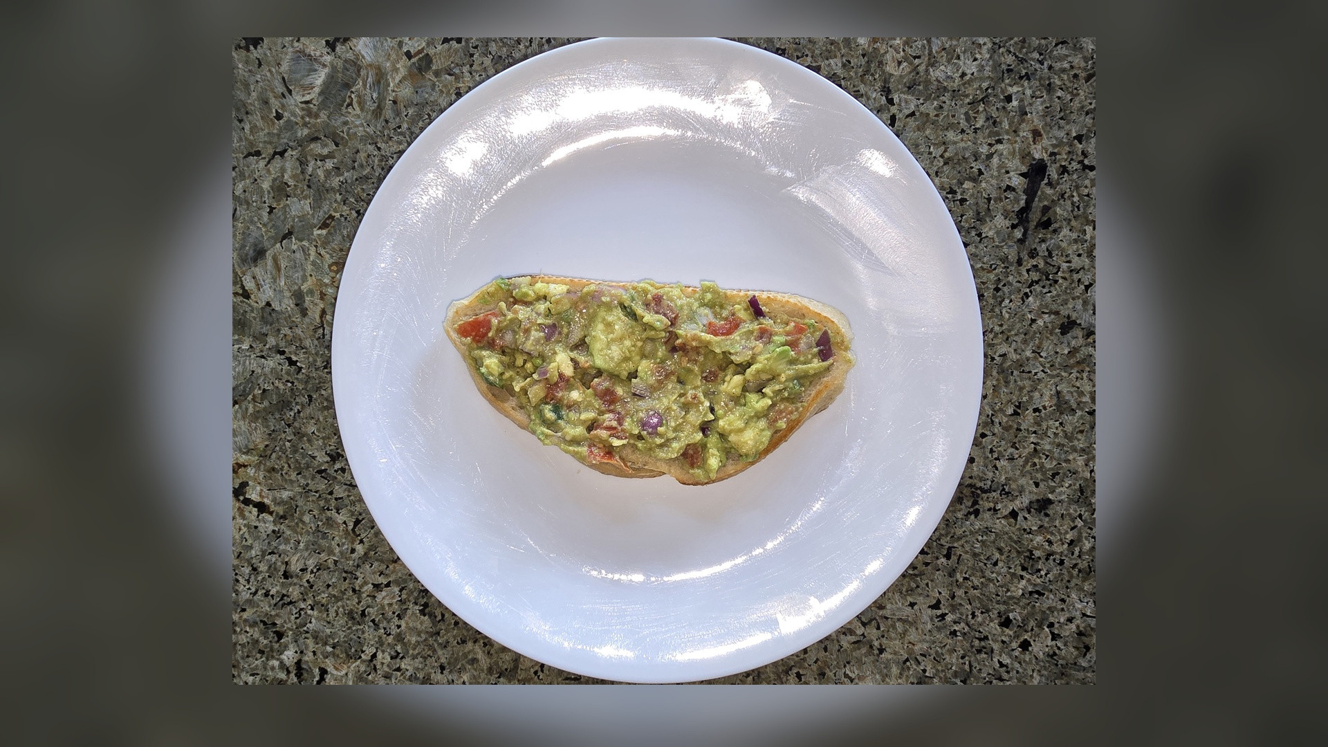 Freshly sliced ripe Hass avocados showing emerald green flesh and seed.