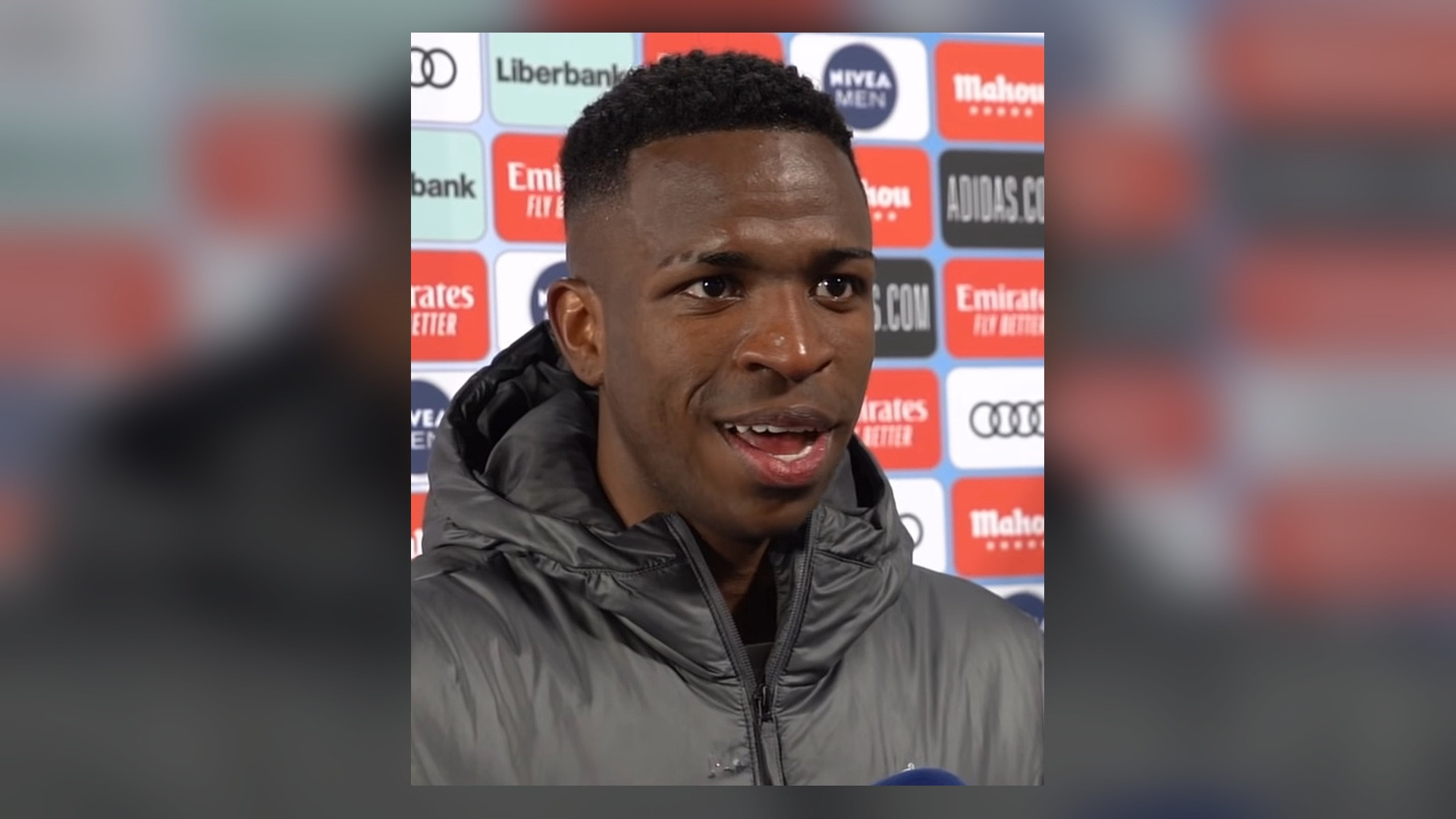 Portrait of Vinícius Júnior smiling during a press interview.