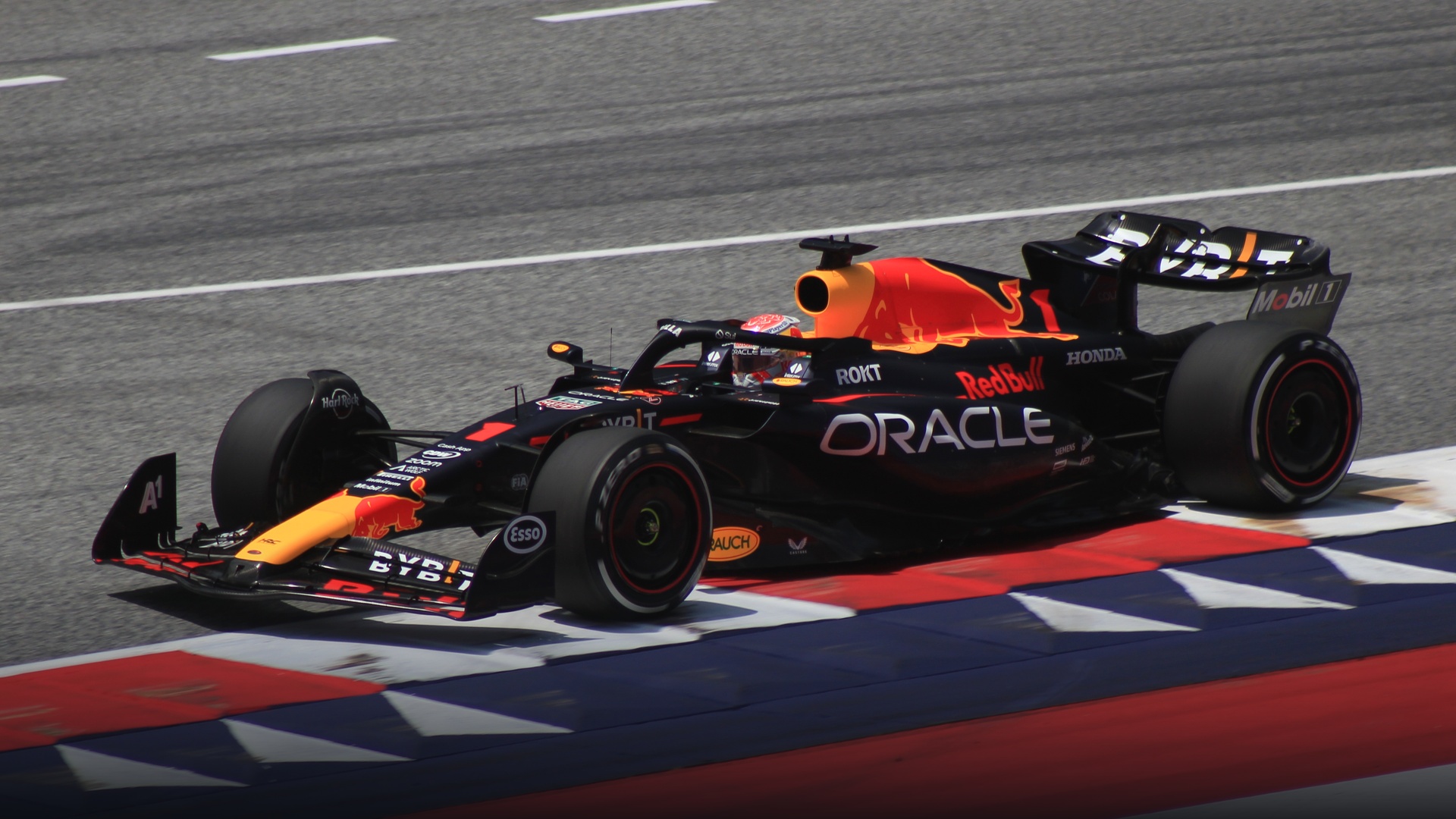 The championship-dominating Red Bull RB19 racing machine carving through a fast sweeping corner.