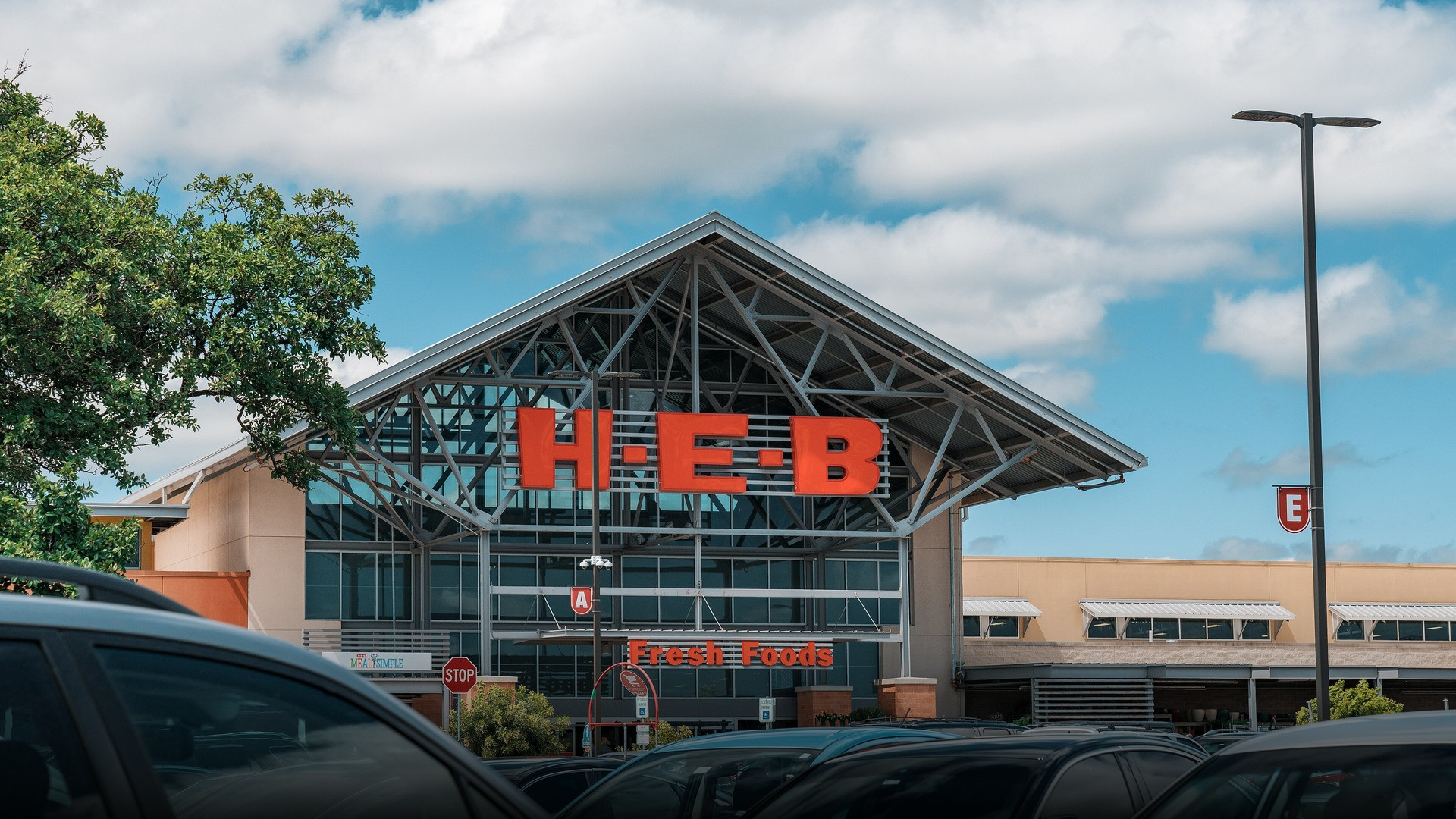 Photograph of H-E-B supermarket storefront celebrating family grocery excellence.