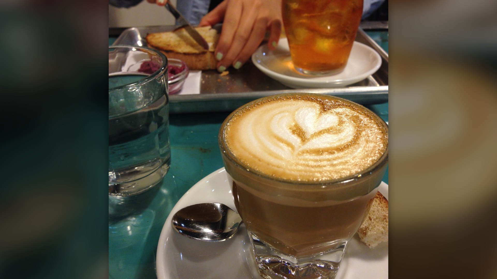 Small glass of cortado with espresso and warm milk and a light foam top