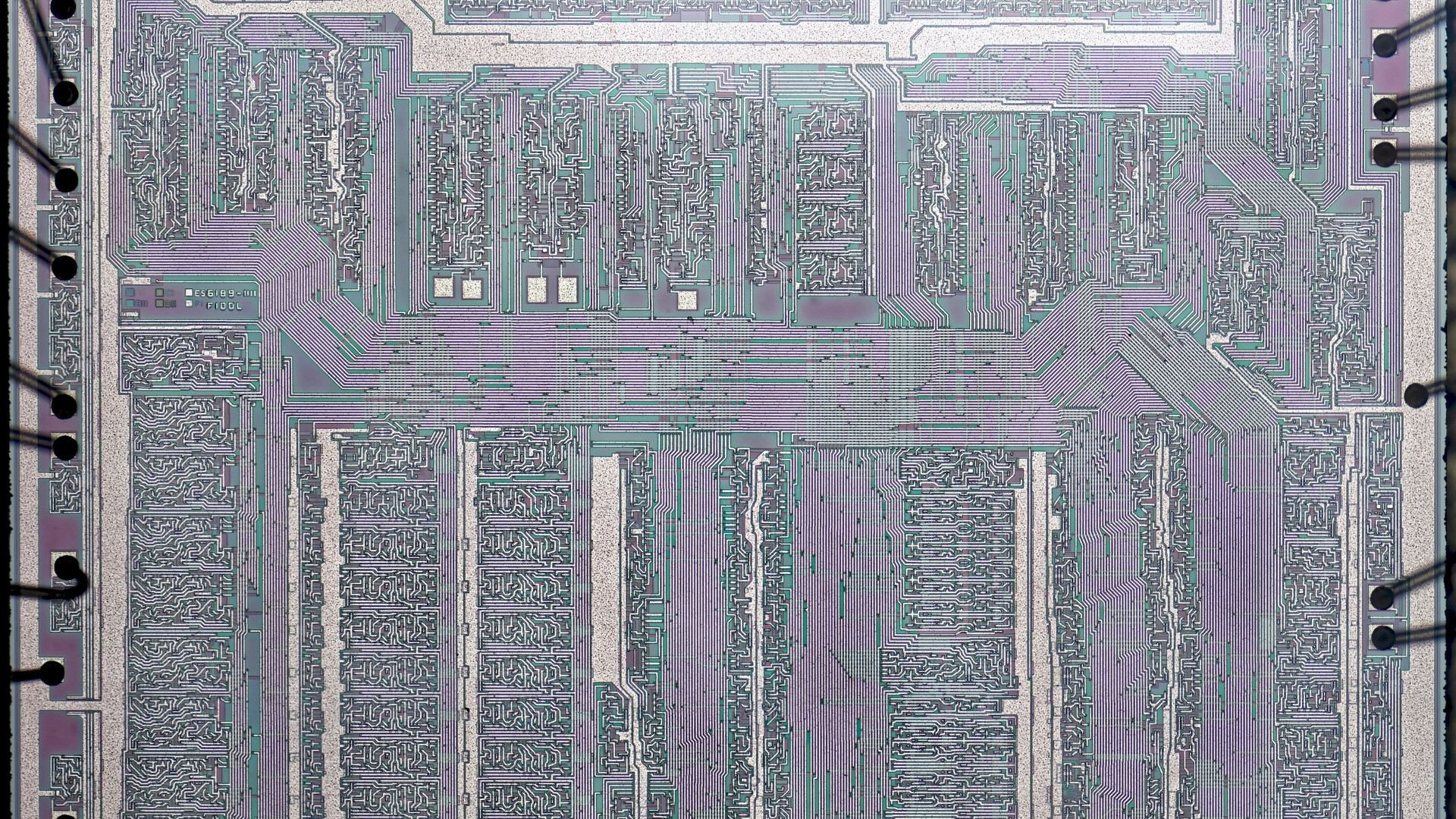 Microscopic top-down view of an integrated circuit silicon die revealing billions of microscopic circuits.