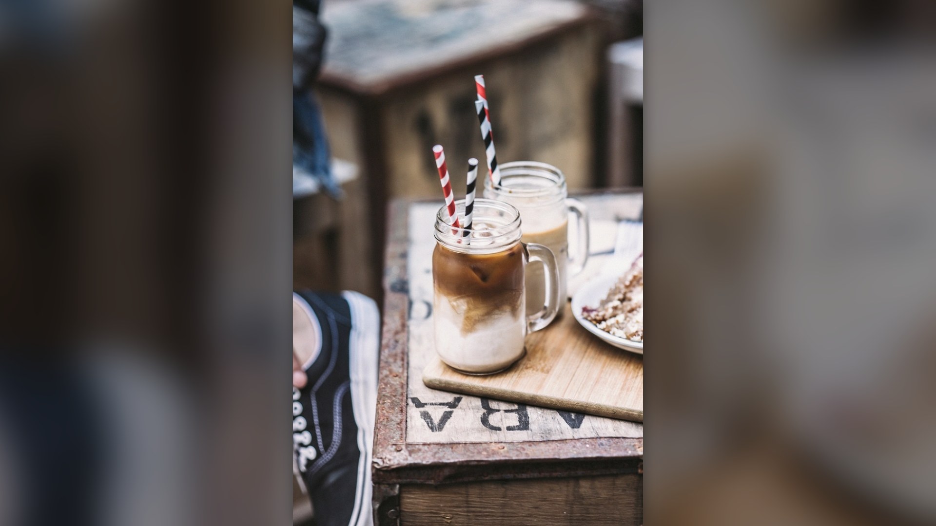 Rustic coffee mug filled with café au lait on a warm wooden surface