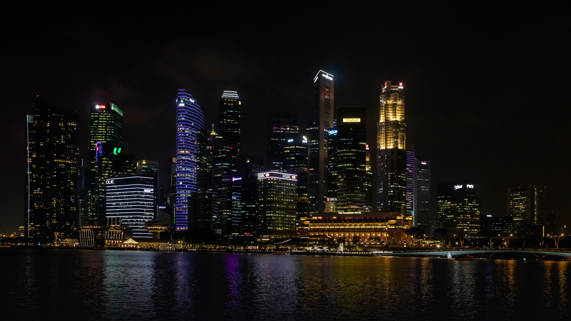 Marina Bay skyline in Singapore brilliantly illuminated at night with modern skyscrapers.