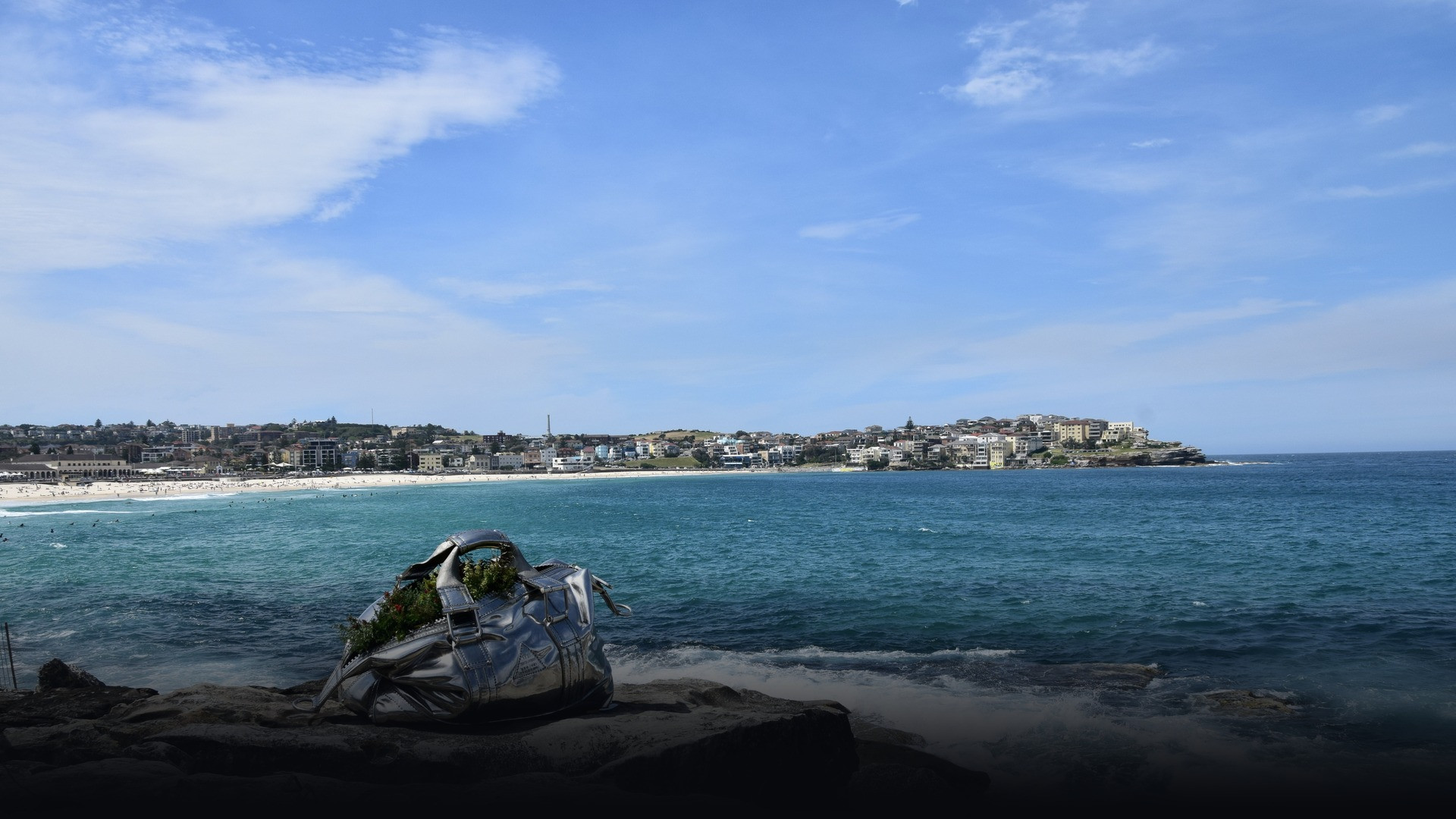 Sweeping golden sands and turquoise coastal surf at Bondi Beach in Sydney.