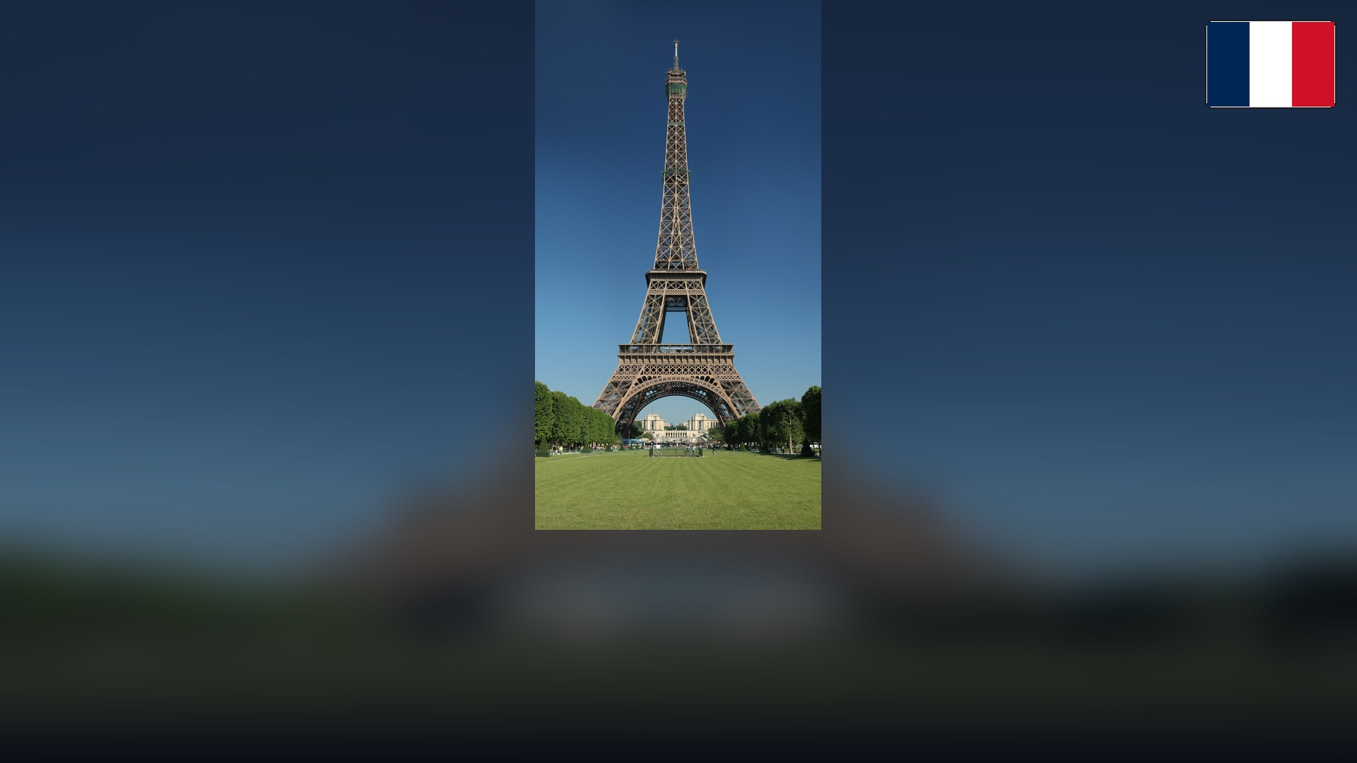 Eiffel Tower in Paris with the French flag in the top right corner.