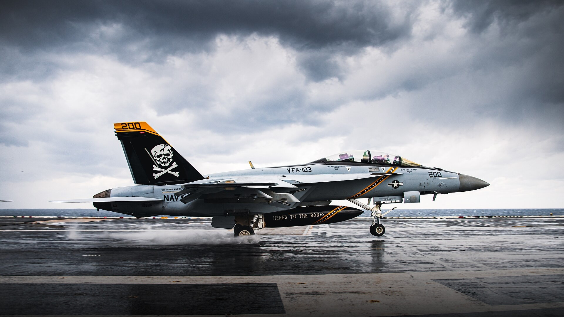 F/A-18F Super Hornet performing a touch-and-go landing on the flight deck of aircraft carrier USS George Washington.