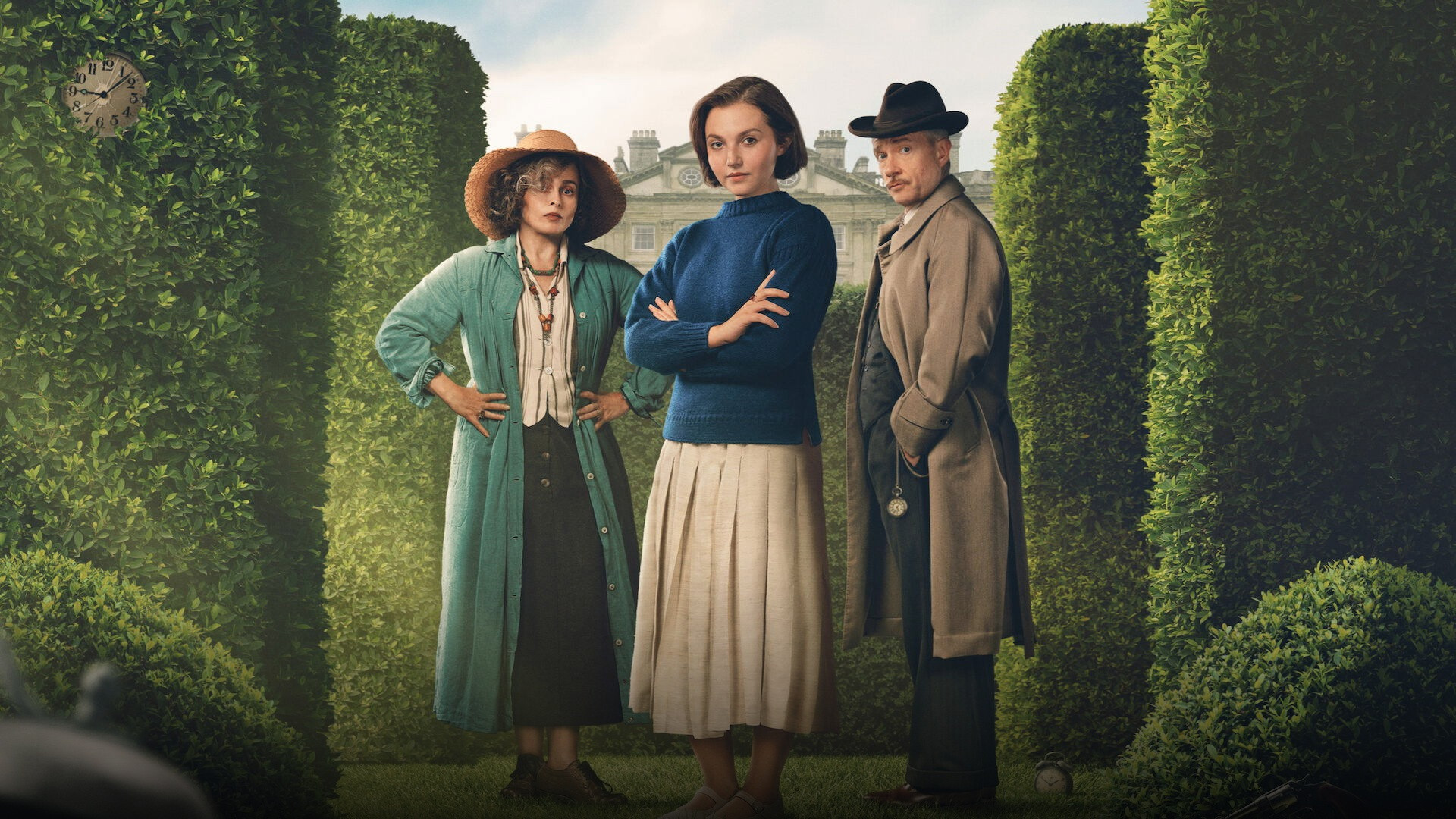 Mia McKenna-Bruce and Helena Bonham Carter standing inside an elegant manor garden.