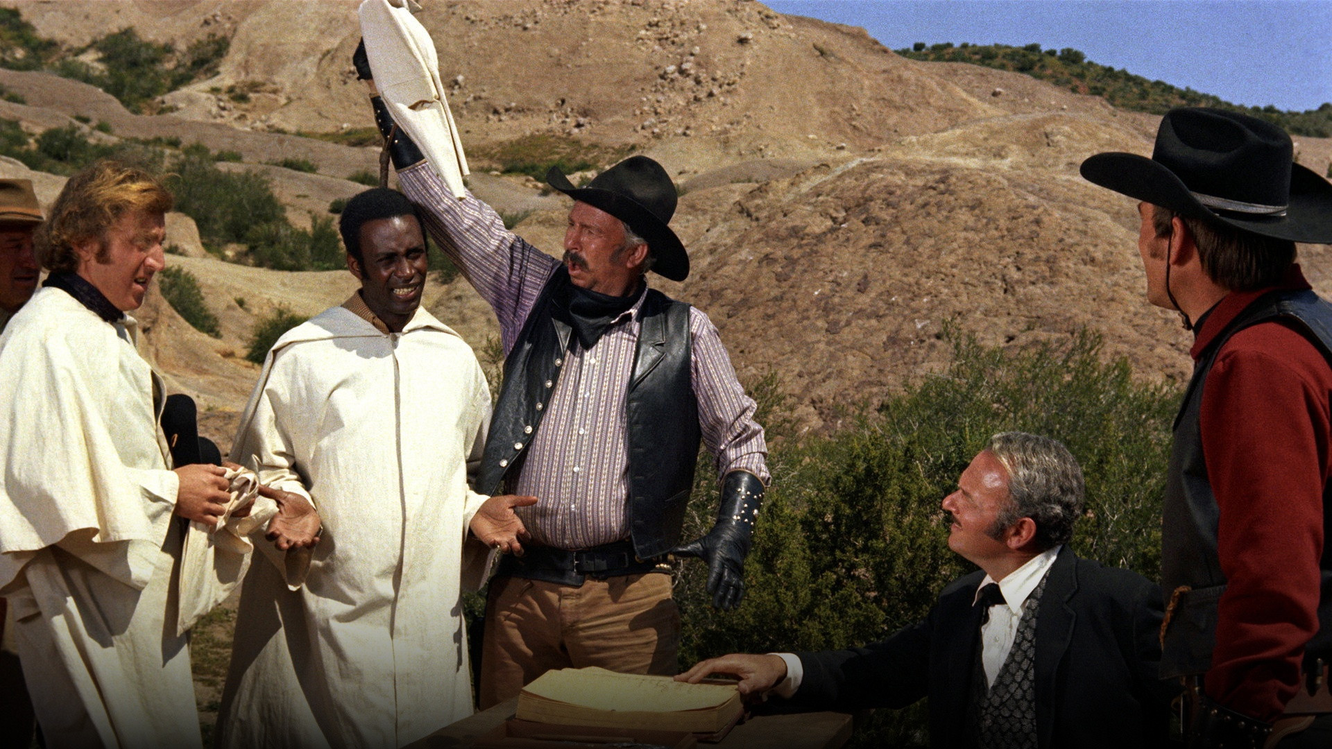 Cleavon Little as Sheriff Bart and Gene Wilder as The Waco Kid in full western gunslinger attire standing together in Blazing Saddles.