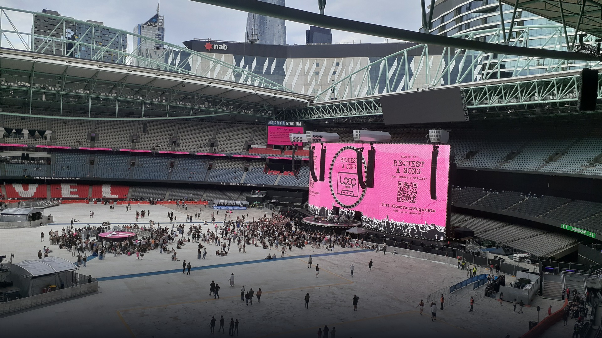 Massive 360-degree stadium stage showing Ed Sheeran's live loop pedal setup.