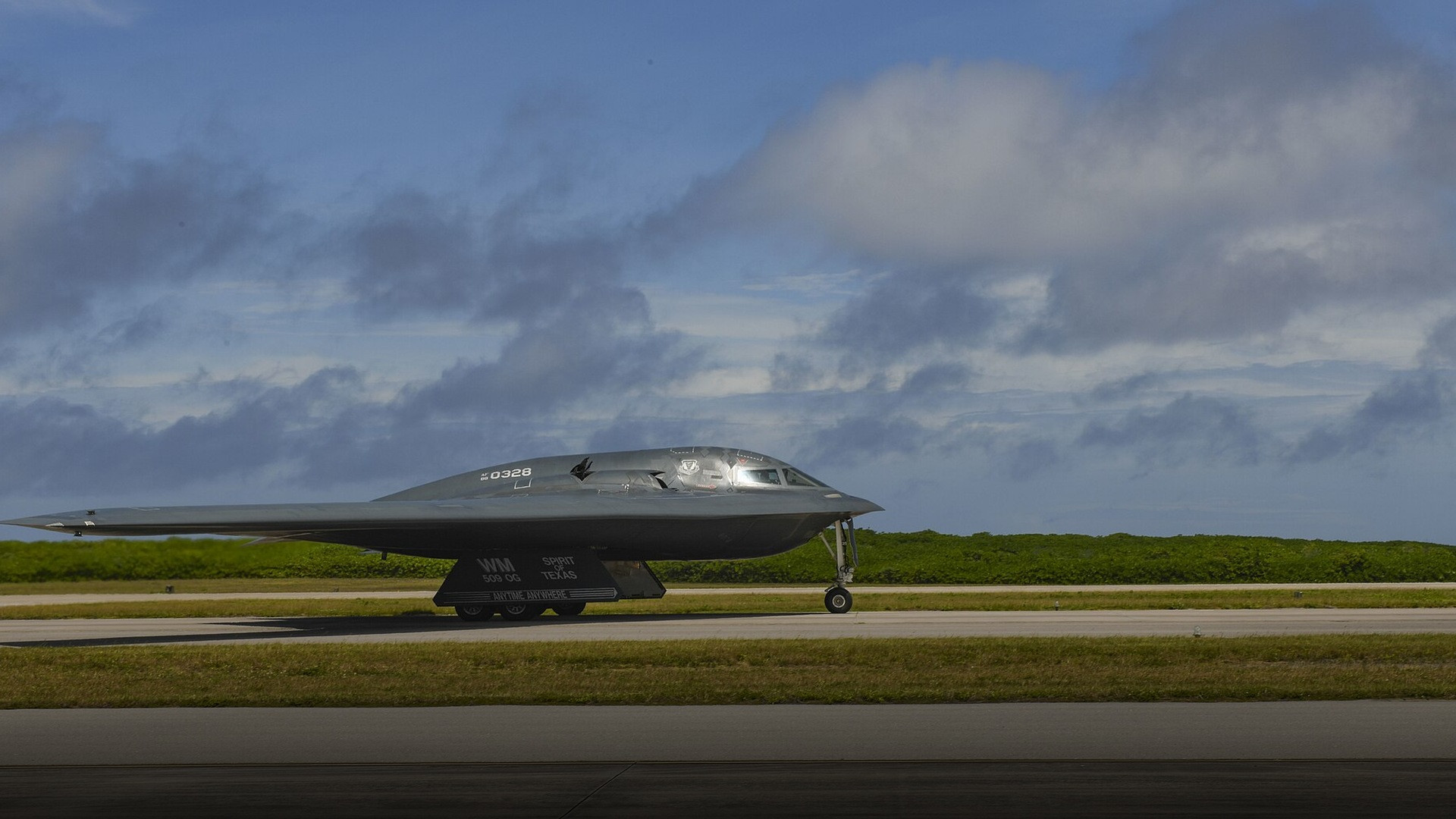 Northrop Grumman B-2 Spirit stealth flying wing heavy bomber cruising through sky.