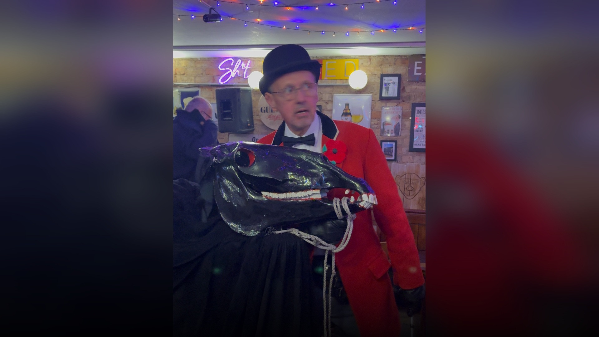 Performers in elaborate traditional folk mummer disguises representing historical Allhallows souling costumes.