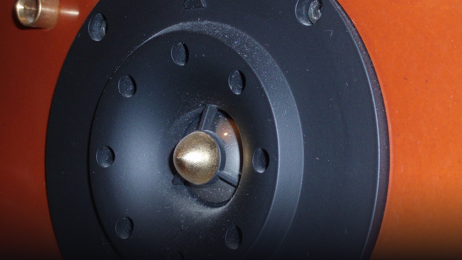 Macro close-up of a precision electroacoustic micro-speaker transducer and directional acoustic driver.