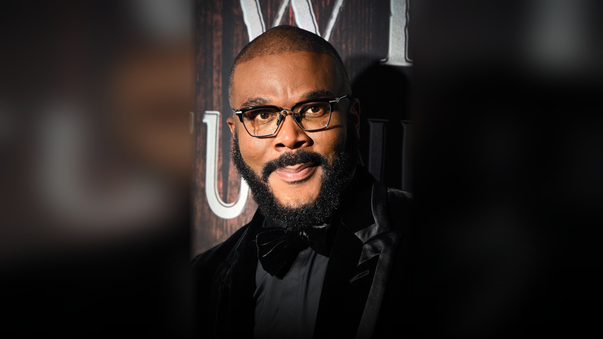 Filmmaker Tyler Perry looking at the camera in a formal portrait.