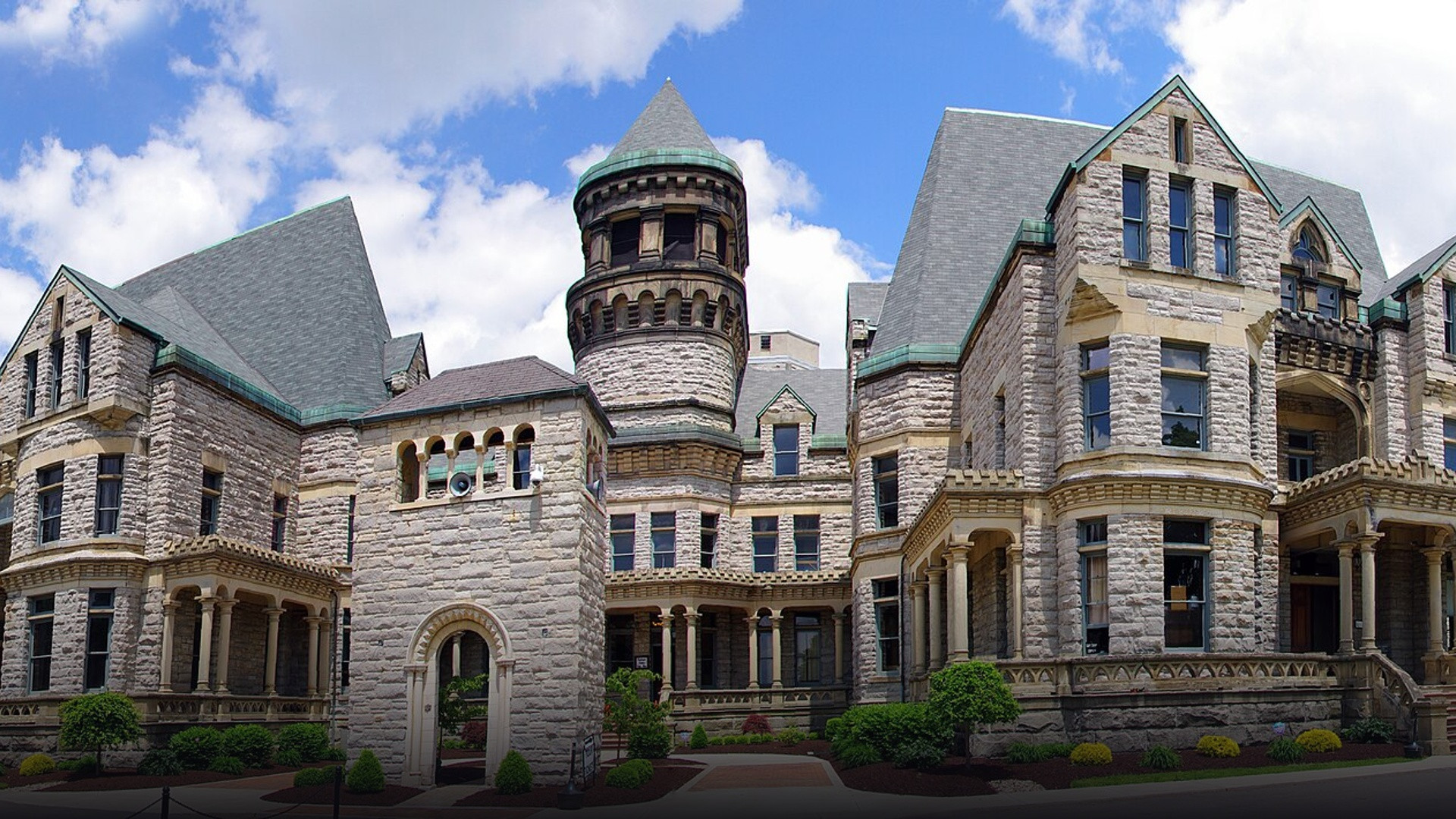 Monumental Gothic Revival and Romanesque stone facade and central towers of the Ohio State Reformatory in Mansfield.