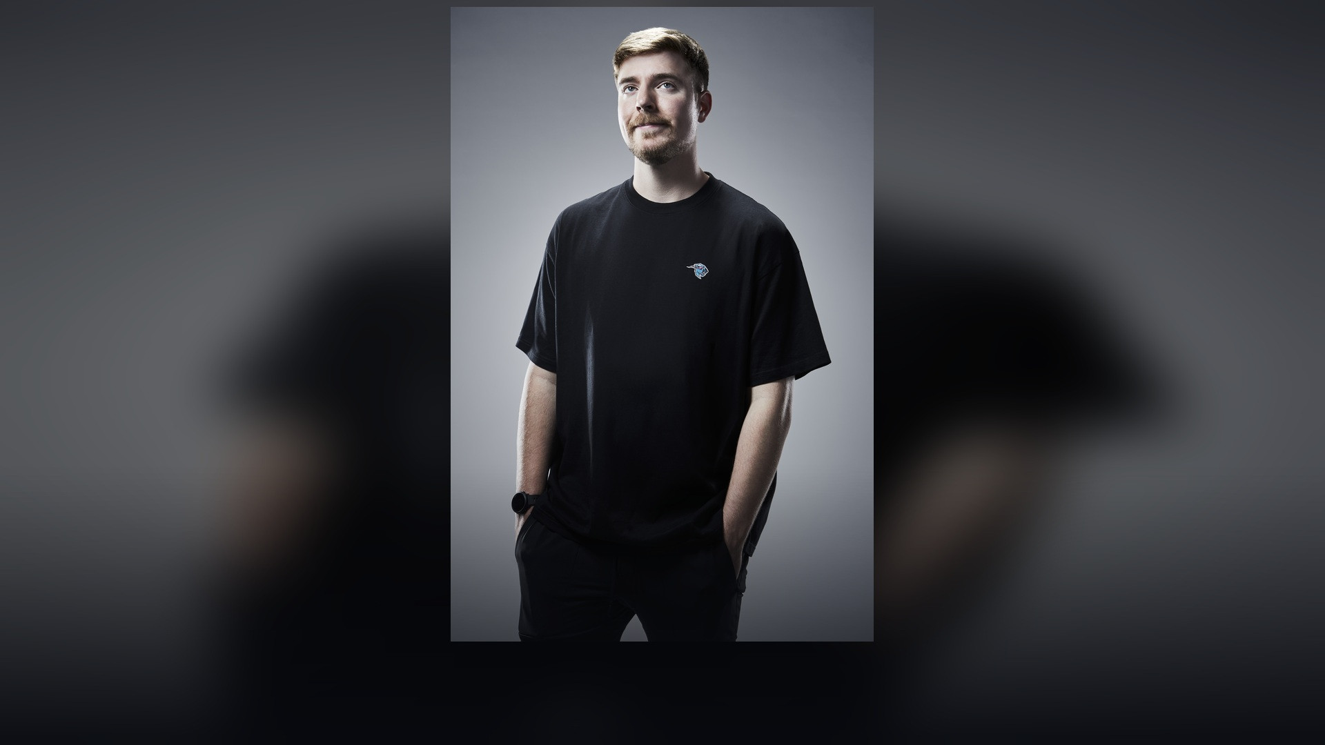 Jimmy Donaldson, MrBeast, in a black shirt against a studio backdrop.
