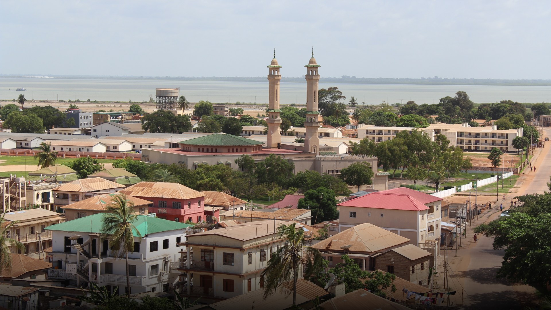 Panoramic view of Banjul skyline with Arch 22 rising above tree-lined streets in The Gambia.