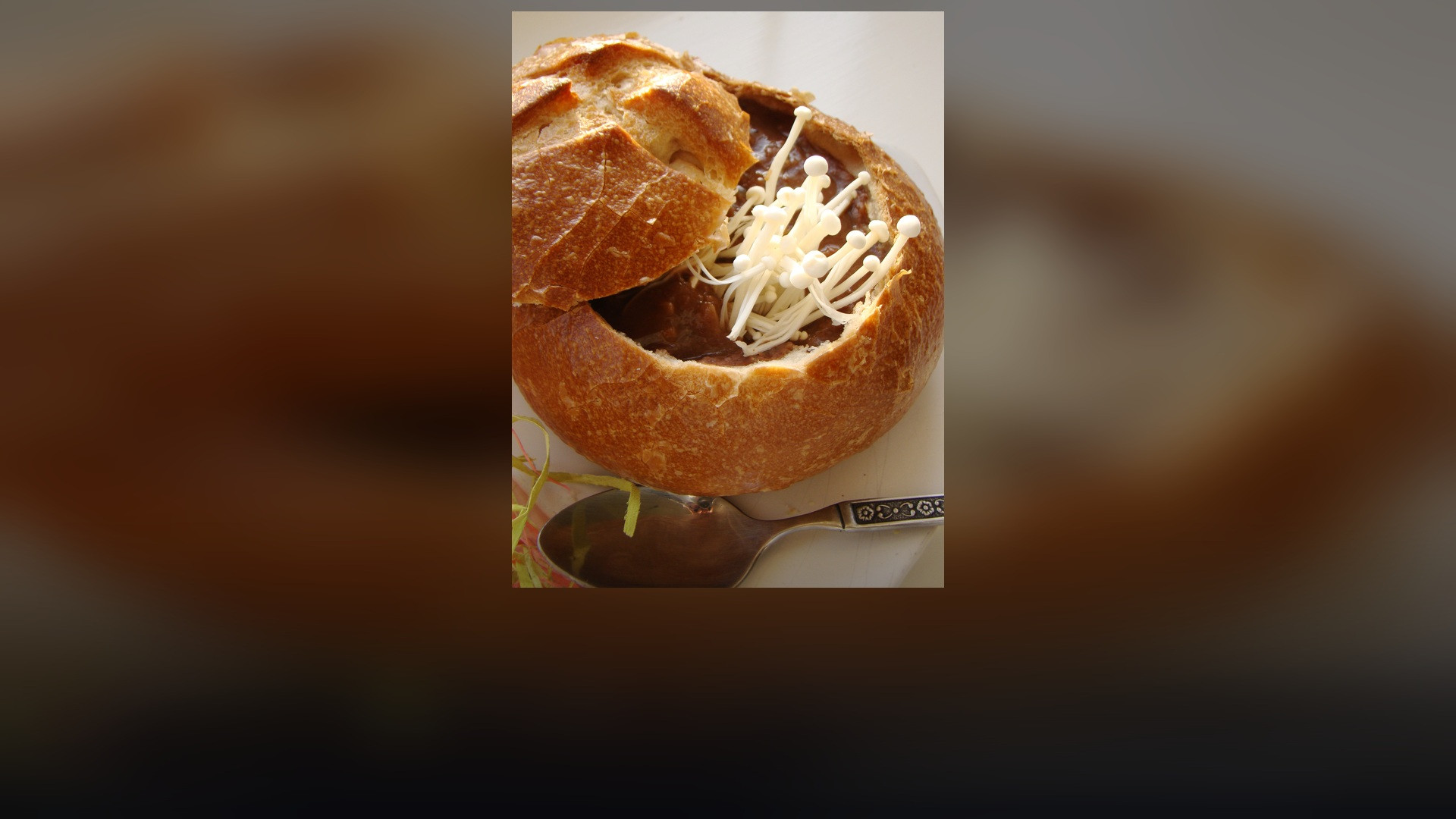 Hearty and nutritious black bean soup served warm in a crusty bread bowl.