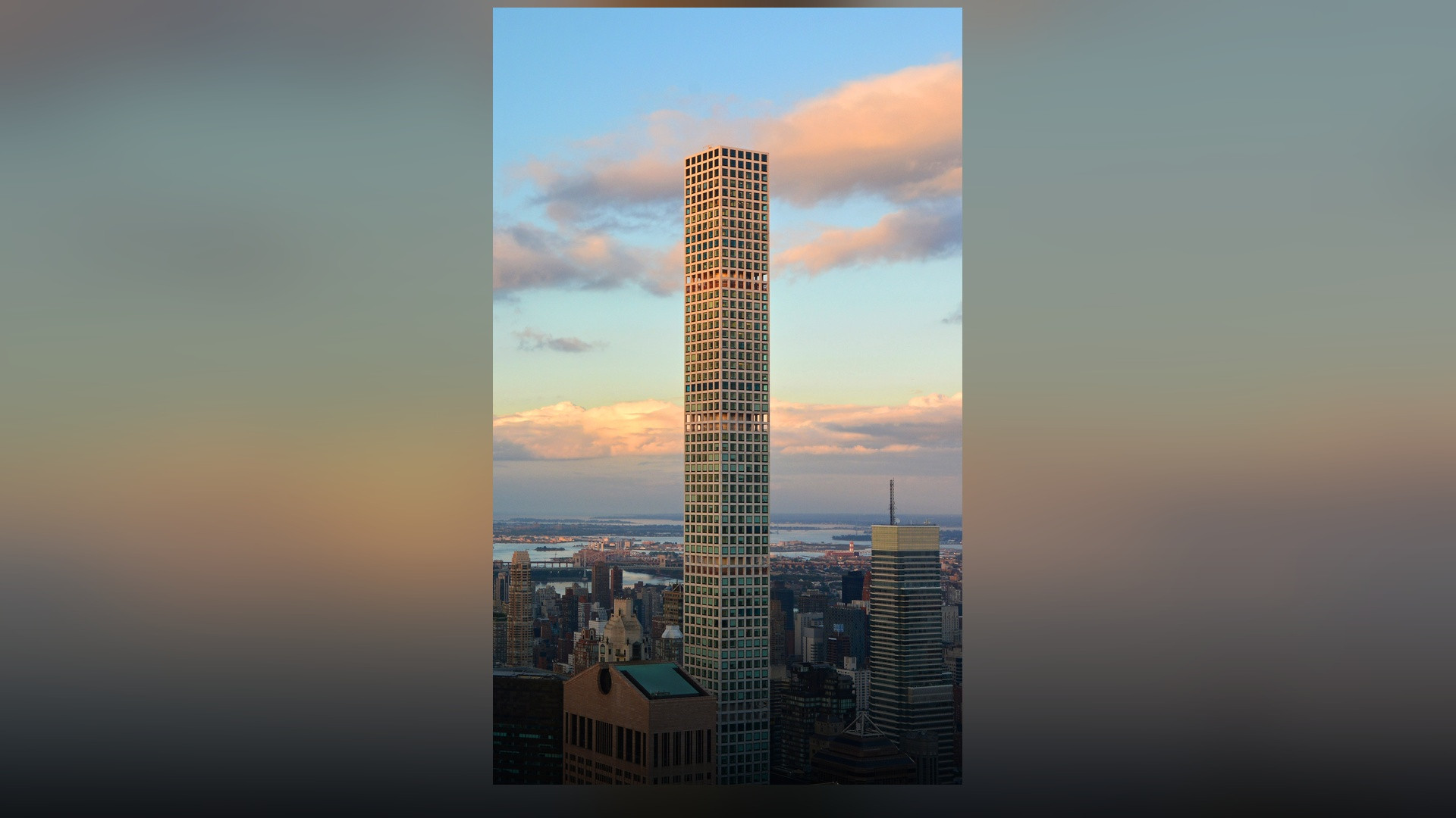 A crisp, straight vertical architectural view of 432 Park Avenue's pure white concrete grid structure rising into a clear blue sky.