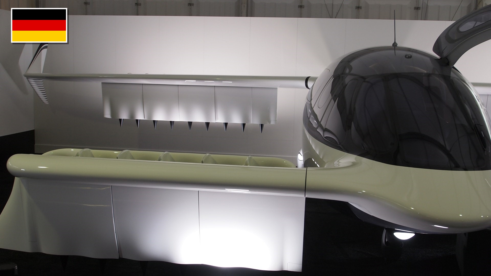 Full-scale 1:1 Lilium Jet regional eVTOL aircraft at ILA Berlin Air Show 2024 with the flag of Germany in the top-left corner.