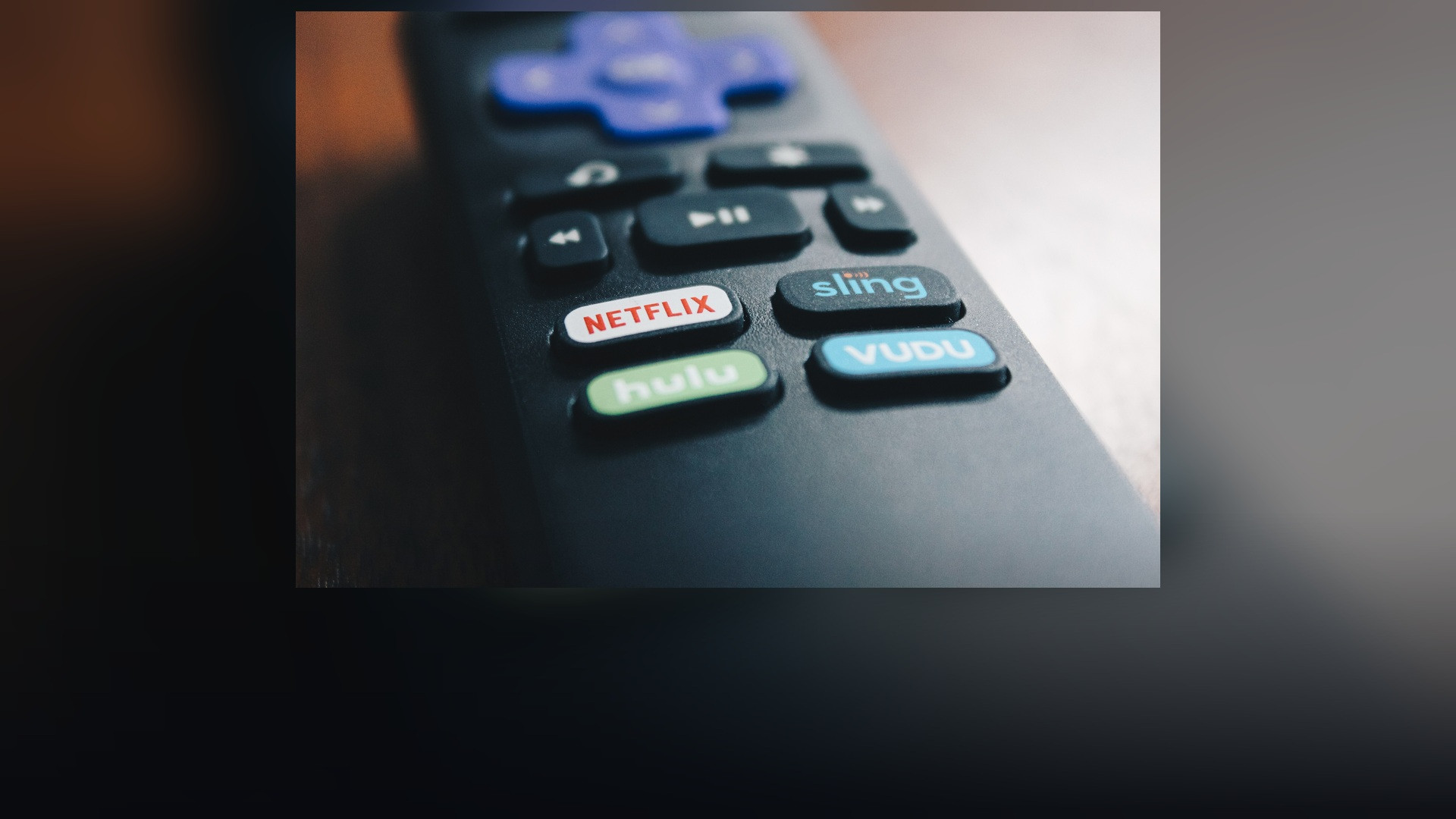 Close-up of a dedicated red Netflix button on a modern smart television remote control.