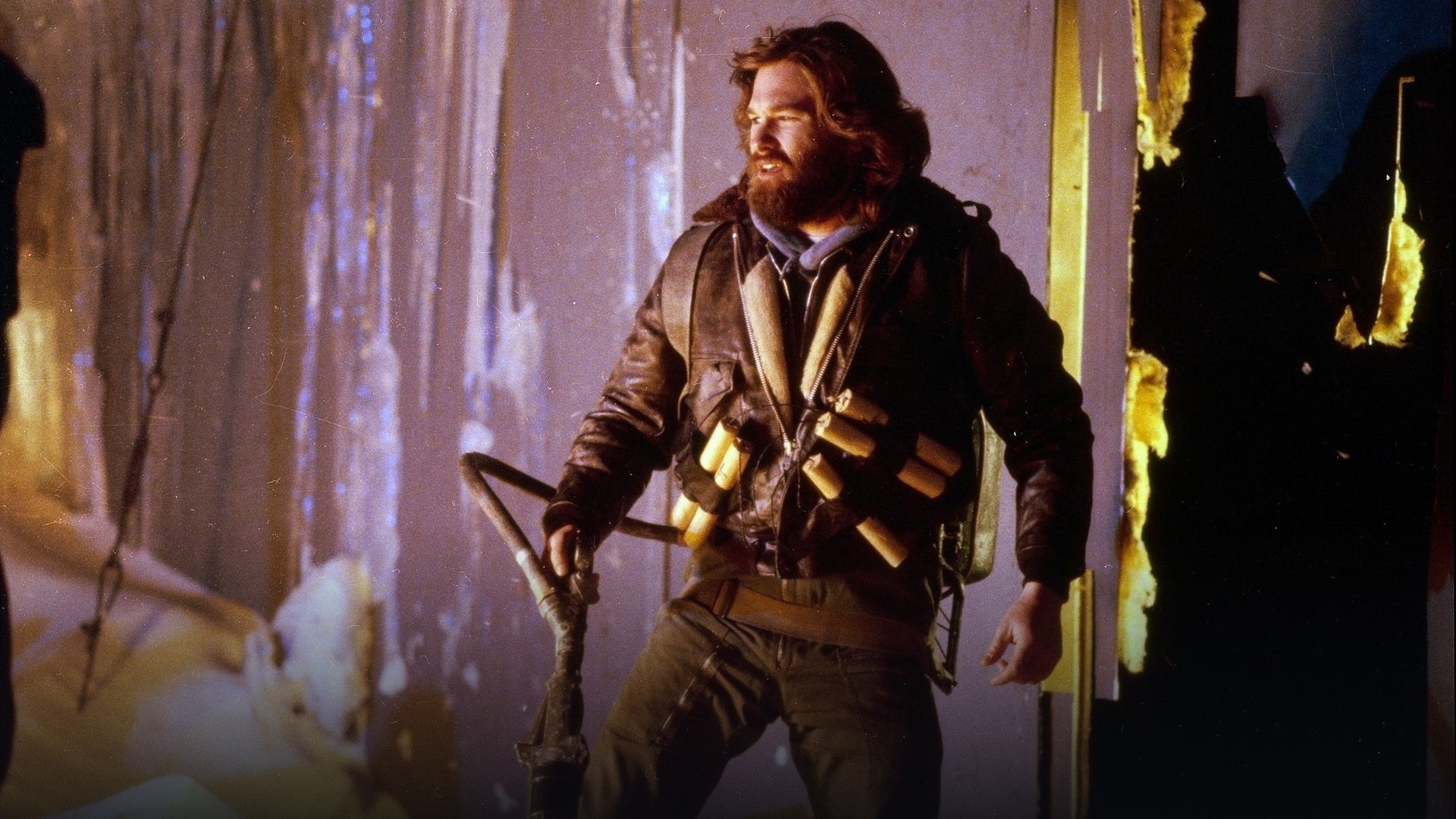 R.J. MacReady holding a flamethrower in the Antarctic snow in The Thing.