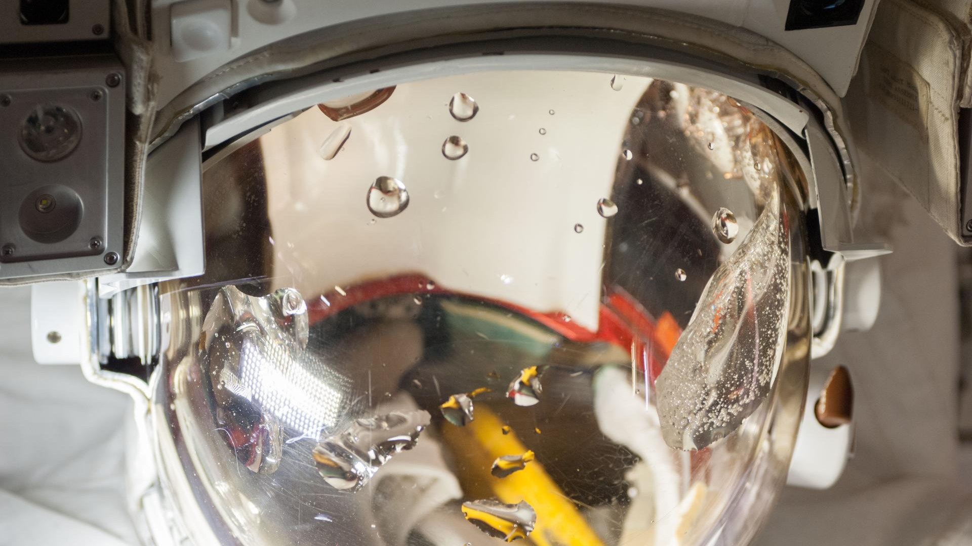 Astronaut inside the airlock preparing for Extravehicular Mobility Unit spacesuit operations