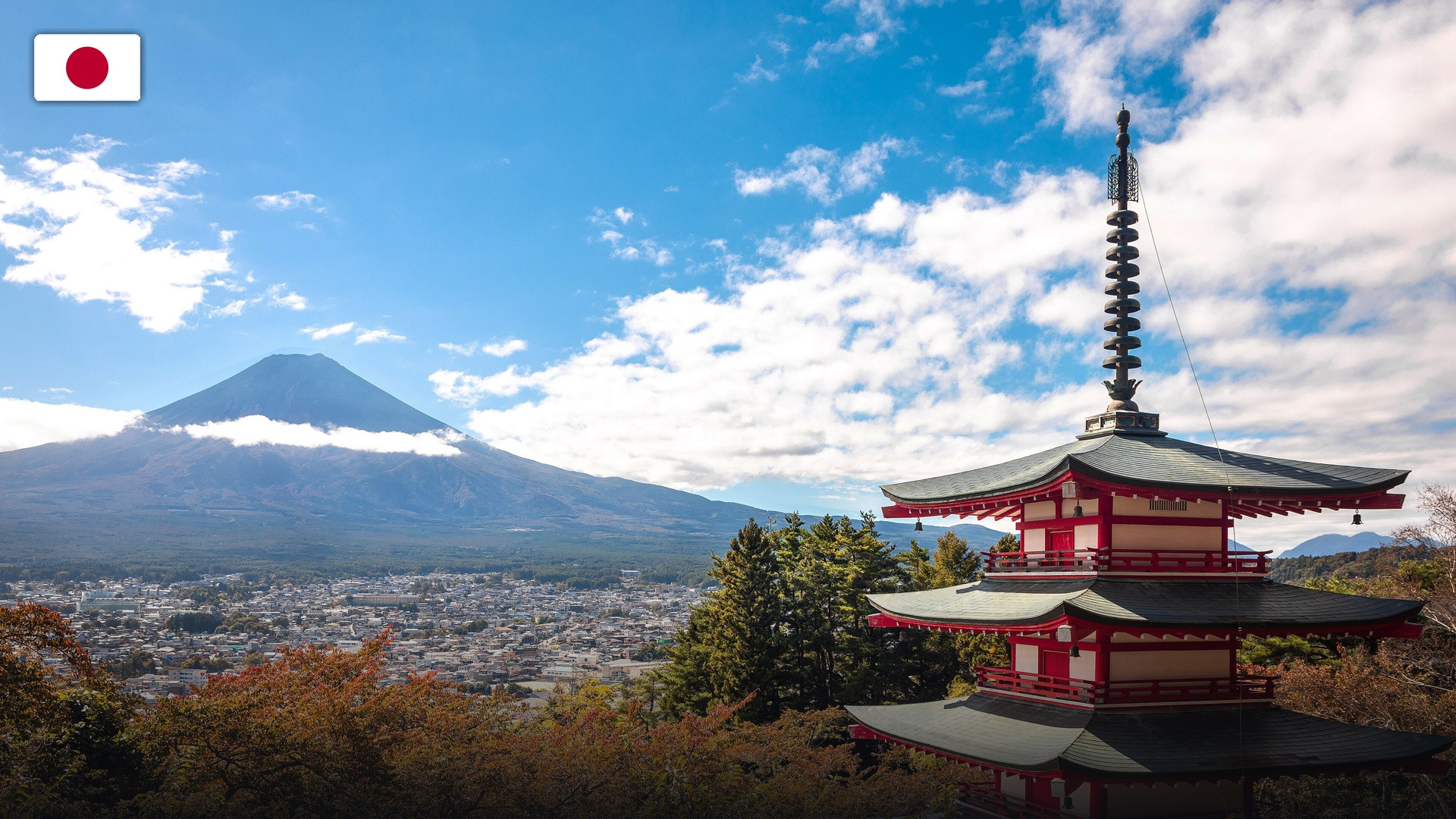 Scenic view of Mount Fuji framed alongside the Chureito Pagoda, with the flag of Japan.