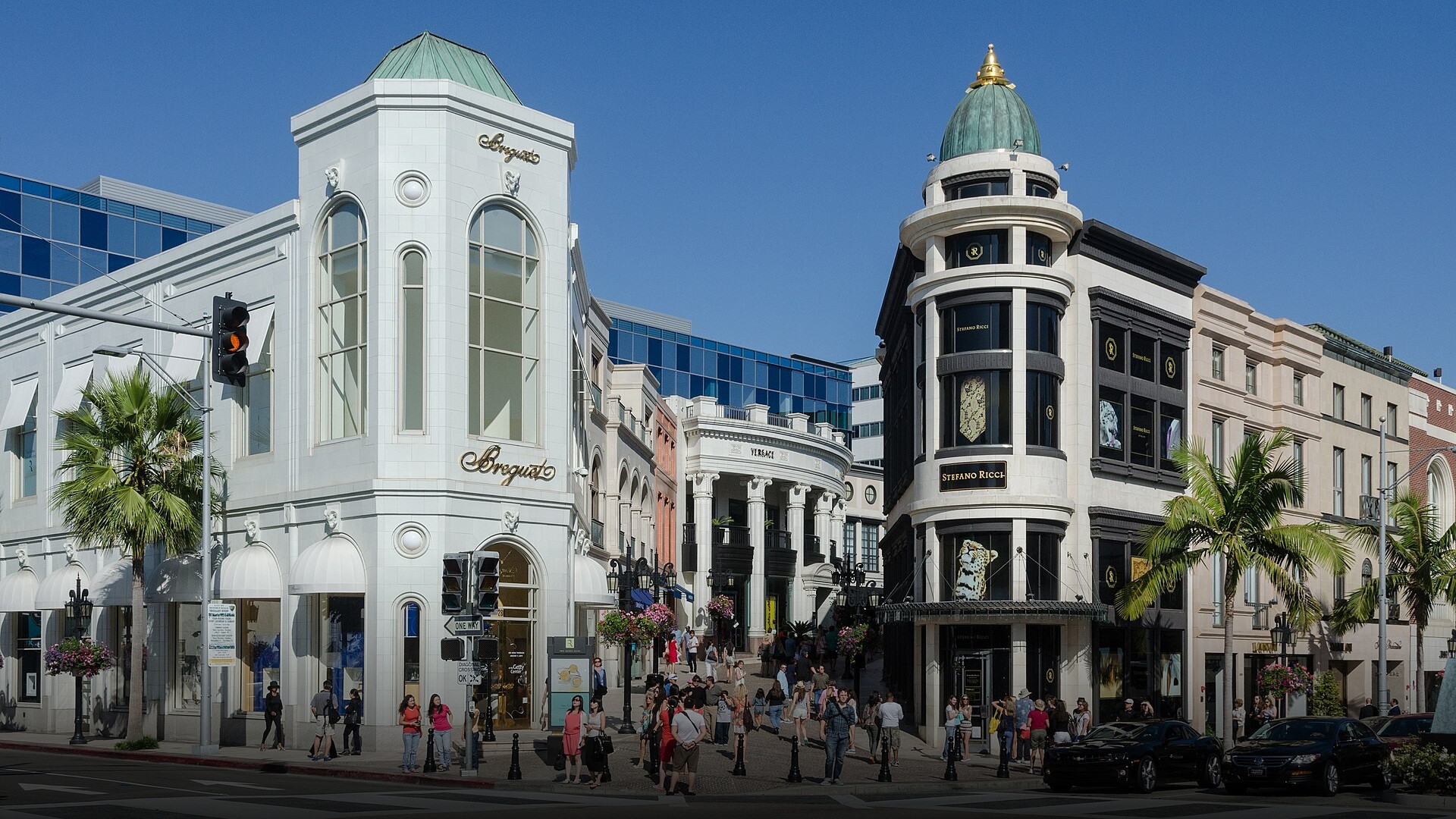 Tall palm trees lining the luxury fashion boutiques and sunny sidewalks of Rodeo Drive.