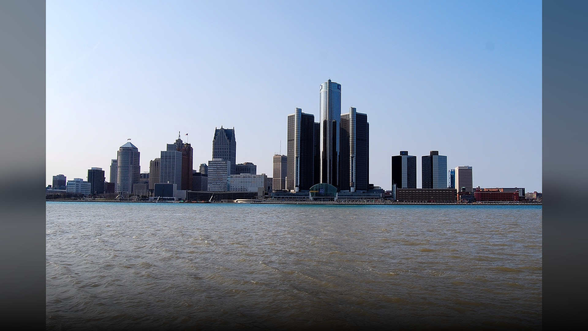Detroit Michigan riverfront skyline featuring the iconic GM Renaissance Center towers.