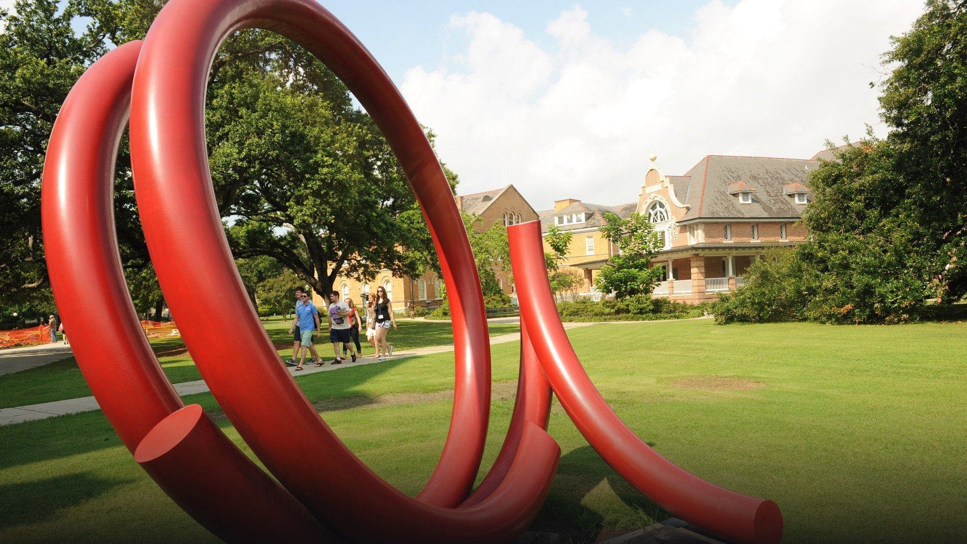 University students walking between academic buildings on a historic American college campus.