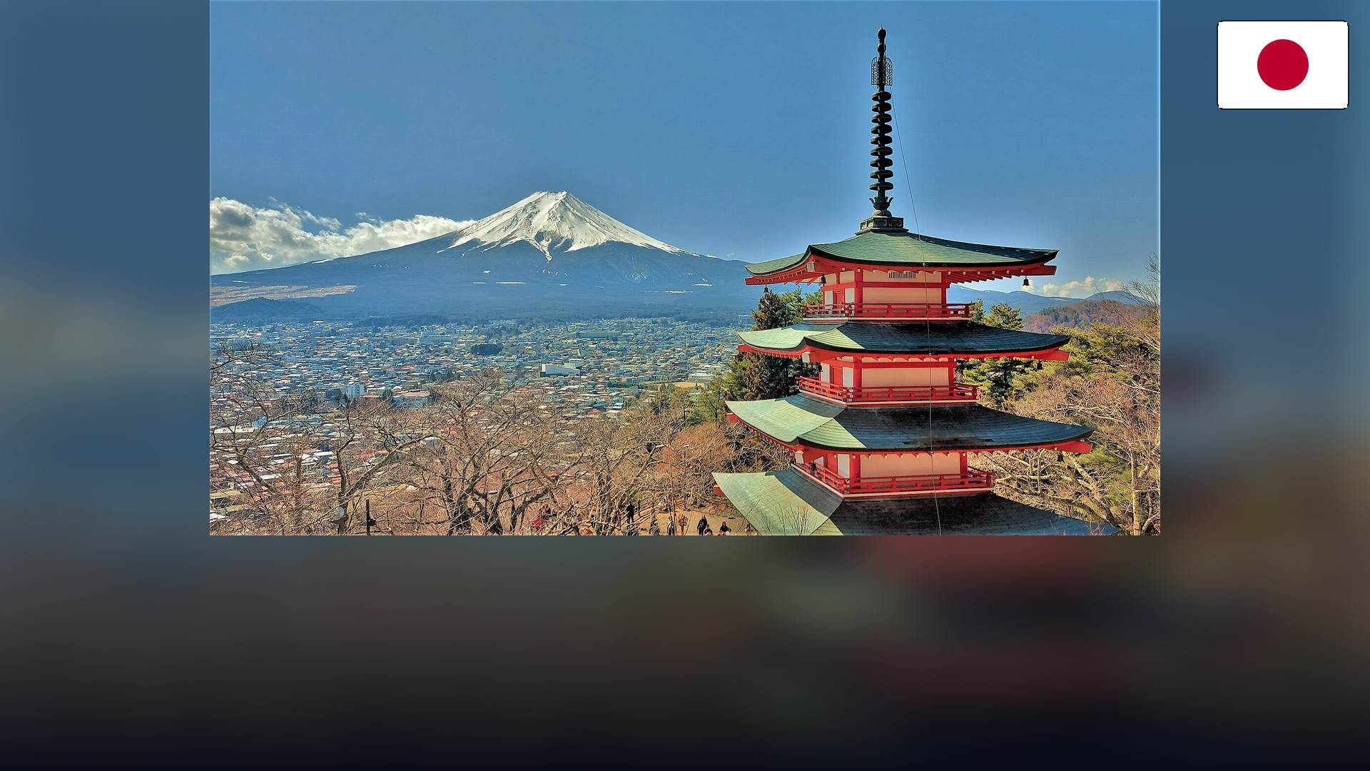Chureito Pagoda with Mount Fuji in the background and the Japanese flag in the top right corner.