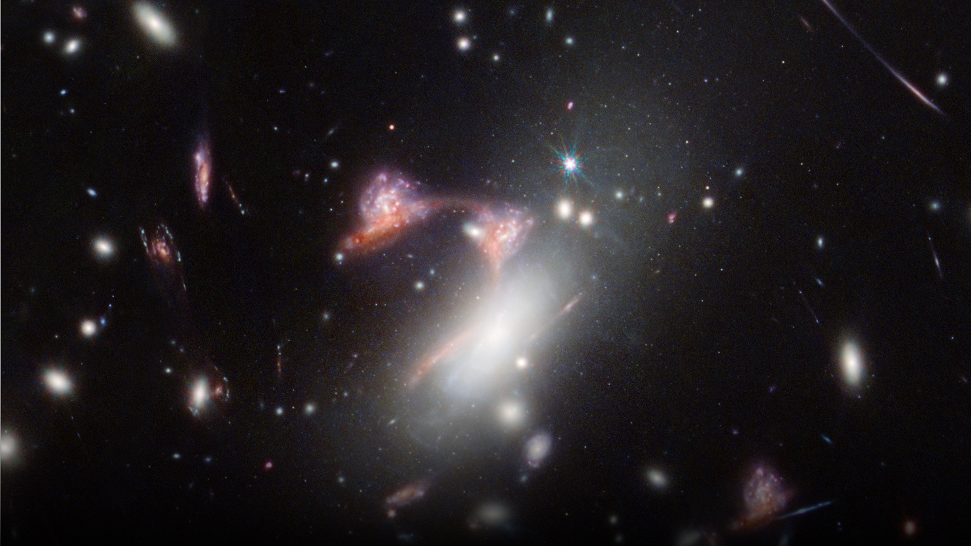 James Webb Space Telescope infrared capture of two colliding galaxies forming a literal glowing celestial question mark.