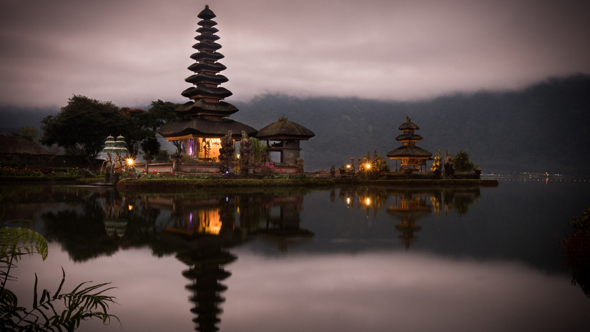 The multi-tiered thatched meru shrines of Pura Ulun Danu Bratan water temple floating on Lake Bratan in Bali.